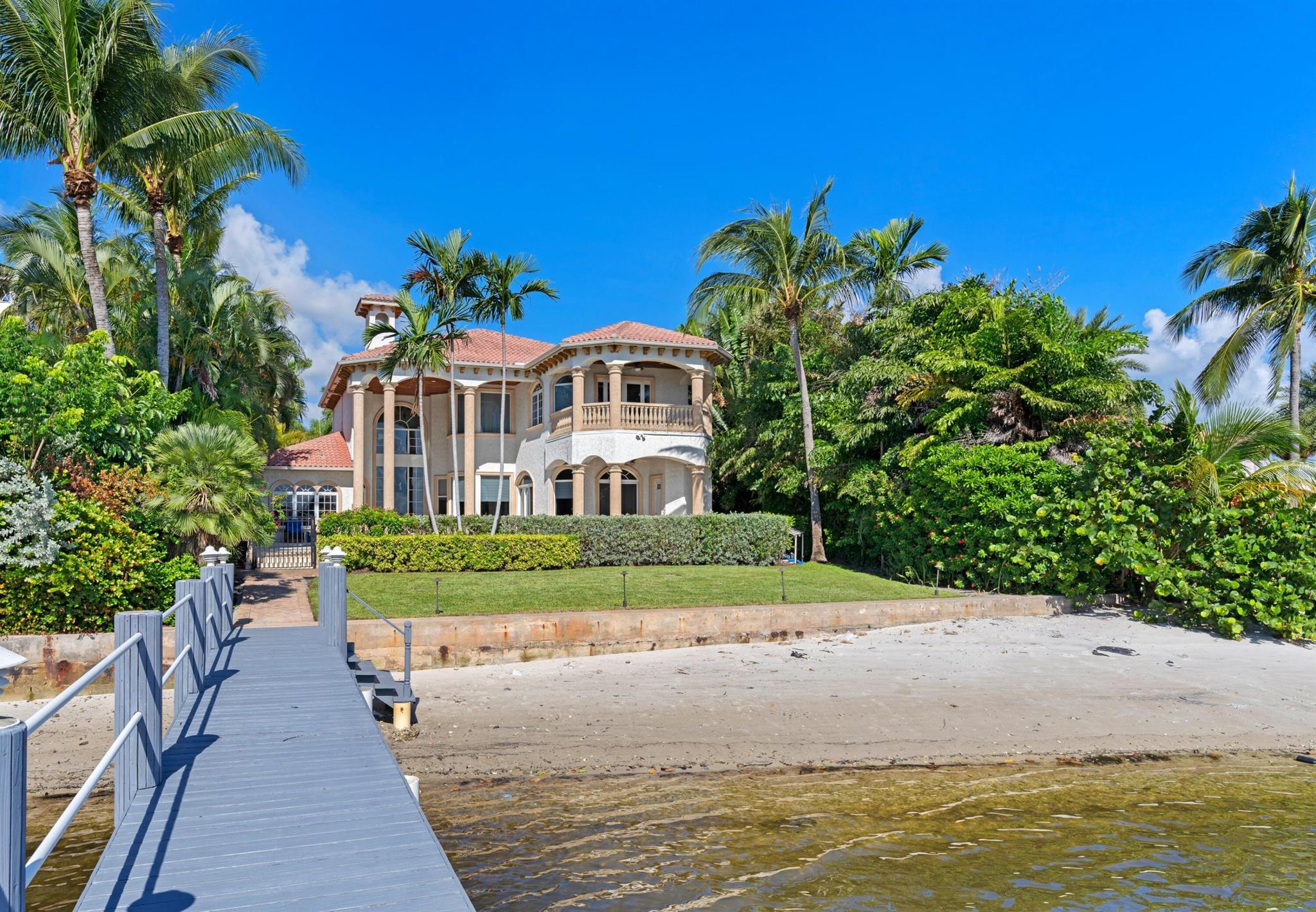 Direct Intracoastal Mediterranean style waterfront home with a private dock, and fabulous views. Built in 2003 this home boasts over 7300 sq. ft., the living areas are 5244 sq. ft. 6 bedrooms, with 1 used as an office, and 6 1/2 baths. All impact glass windows, and doors, solid CBS construction, and a 3 car garage. Completely walled, with gated entry, and large parking area. The foyer entry is a 2 story atrium in design, with stone finished walls, and a beautiful marble staircase. The living area has all marble flooring. Gourmet kitchen with gas appliances, all facing the water, and opening to the great room. The 1st floor has 4 bedrooms, the master BR is on the 2nd floor, with a large mixed use game room/office with elevator access. 76 Ft, on the water, with ocean access and no bridges.