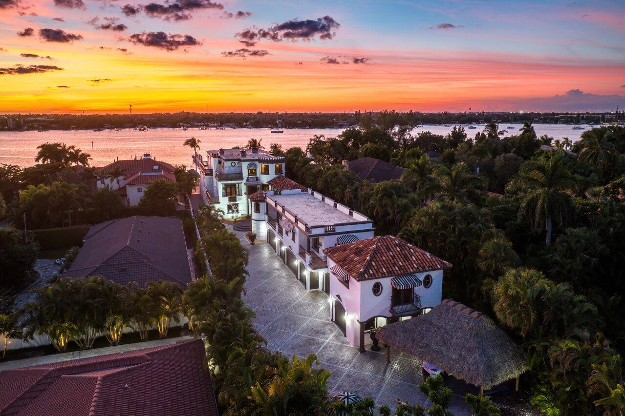 Introducing Chateau Rosmar, an exquisite 3/4 acre private Mediterranean Intracoastal estate on Hypoluxo Island. This opulent masterpiece offers 7 bedrooms, a movie theater, a gym,10 bathrooms, 3 half baths, and a 9 car garage. There are 3 laundry rooms and a thoughtfully designed floor plan. The estate features a 250-foot boardwalk for all sizes of motor yachts and more. Inside, you'll find a grand entry foyer, a 3-story marvel of marble, brass, and stained glass. The gourmet kitchen boasts double islands, custom cabinetry, and a service bar. A formal dining room and a maid's suite are additional highlights. Chateau Rosmar offers a 10-seat home theater and an elevator for convenience. The primary suite includes a private gym, dual ensuite baths, and a dedicated laundry room. Her primary closet features 18 custom glass-enclosed wardrobe cabinets. Additionally, there is a 3/2 attached guest house with a full kitchen and a 1/1 studio with a partial kitchen. These spaces add versatility and flexibility to the property. Outside, there's a pool, spa, gazebo, sundeck, and a double barbecue grill setup. Hurricane-proof doors and windows provide peace of mind. A 250-foot dock with 7.5 feet at low tide is perfect for boating enthusiasts. Chateau Rosmar is an exclusive waterfront estate near Palm Beach International Airport, restaurants, and shopping.