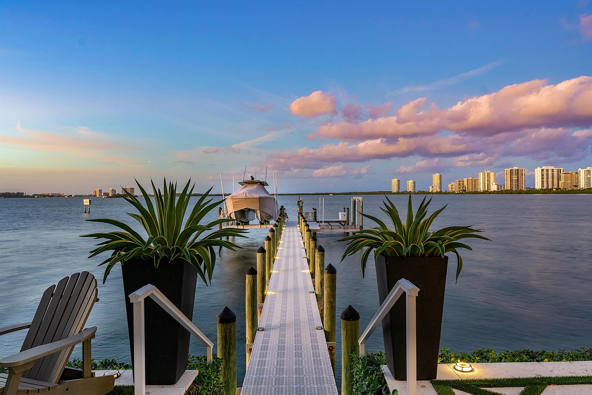 Discover the epitome of luxurious coastal living at 1030 Pine Point, a West Indies-inspired masterpiece built in 2017. This architecturally refined residence offers stunning Intracoastal views and a spacious layout featuring 5 bedrooms, 6.5 bathrooms, and a stylish West Indies design throughout. With 150 feet of direct waterfront access, including a 125-foot dock with a boat lift, this property seamlessly blends craftsmanship and quality, ensuring timeless elegance. Positioned just minutes from the inlet and steps from the beautiful Singer Island beaches, this home is not merely a residence; it's a lifestyle statement, providing unparalleled comfort and sophistication. Elevate your living experience at 1030 Pine Point.