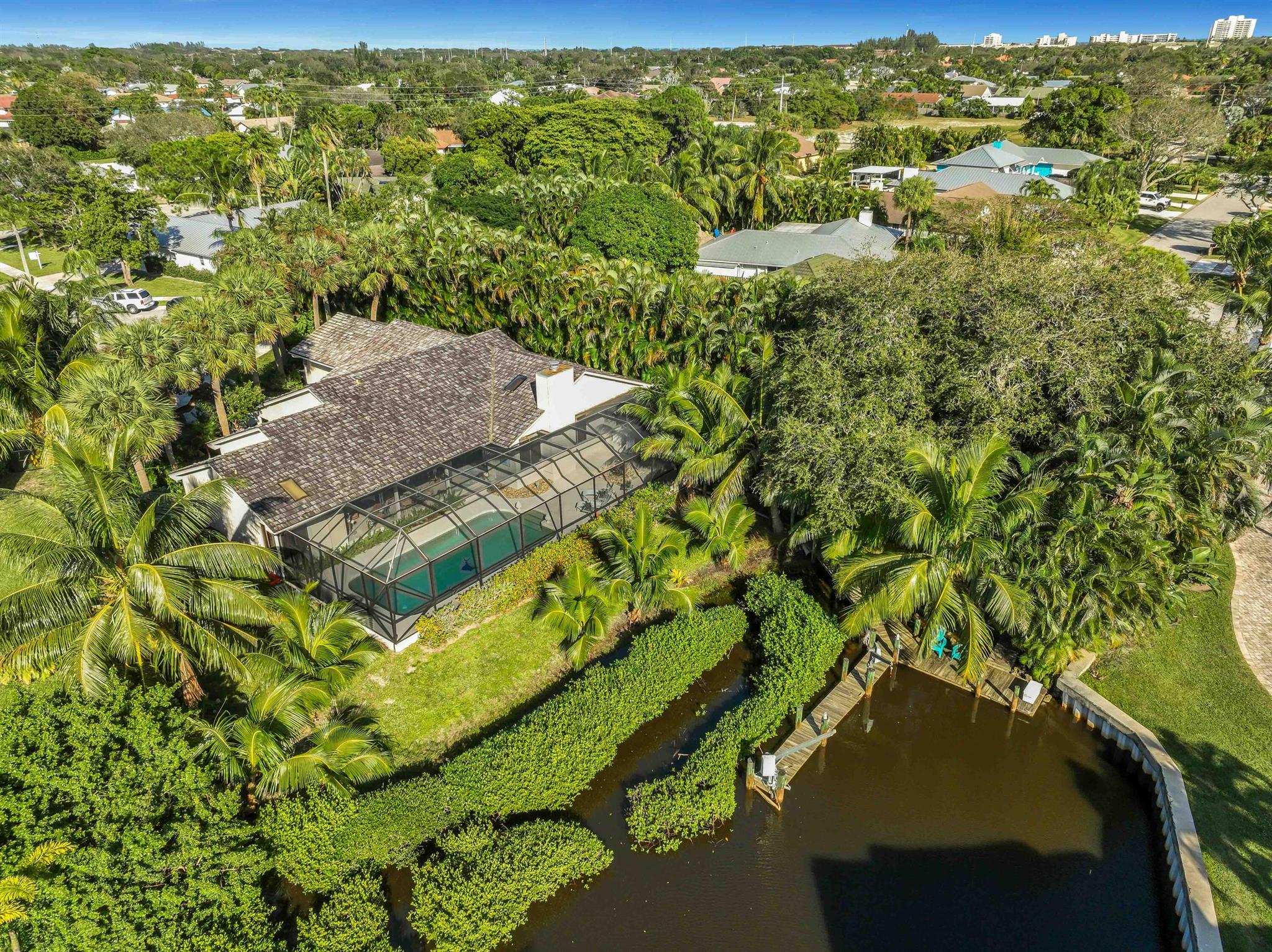 Own a slice of waterfront paradise with this stunning 4-bedroom, 3.5-bathroom single-family pool home, boasting direct ocean access from your backyard! This .46 acre opportunity screams possibilities: expand up to an additional 4,000 sq.ft., customize, or simply relish the tranquility that Tequesta has to offer. Oak shake and cedar siding blend seamlessly with the lush greenery, while the natural wood interior and cozy fireplace create a warm and inviting atmosphere. Vaulted ceilings, split floor plan and panoramic views to your backyard oasis are key features to the bones of this home. Whether you're expanding your family or retiring, Tequesta has it all; top-rated schools, restaurants & nightlife, golf courses, and close proximity to beaches, parks, and things to do!
