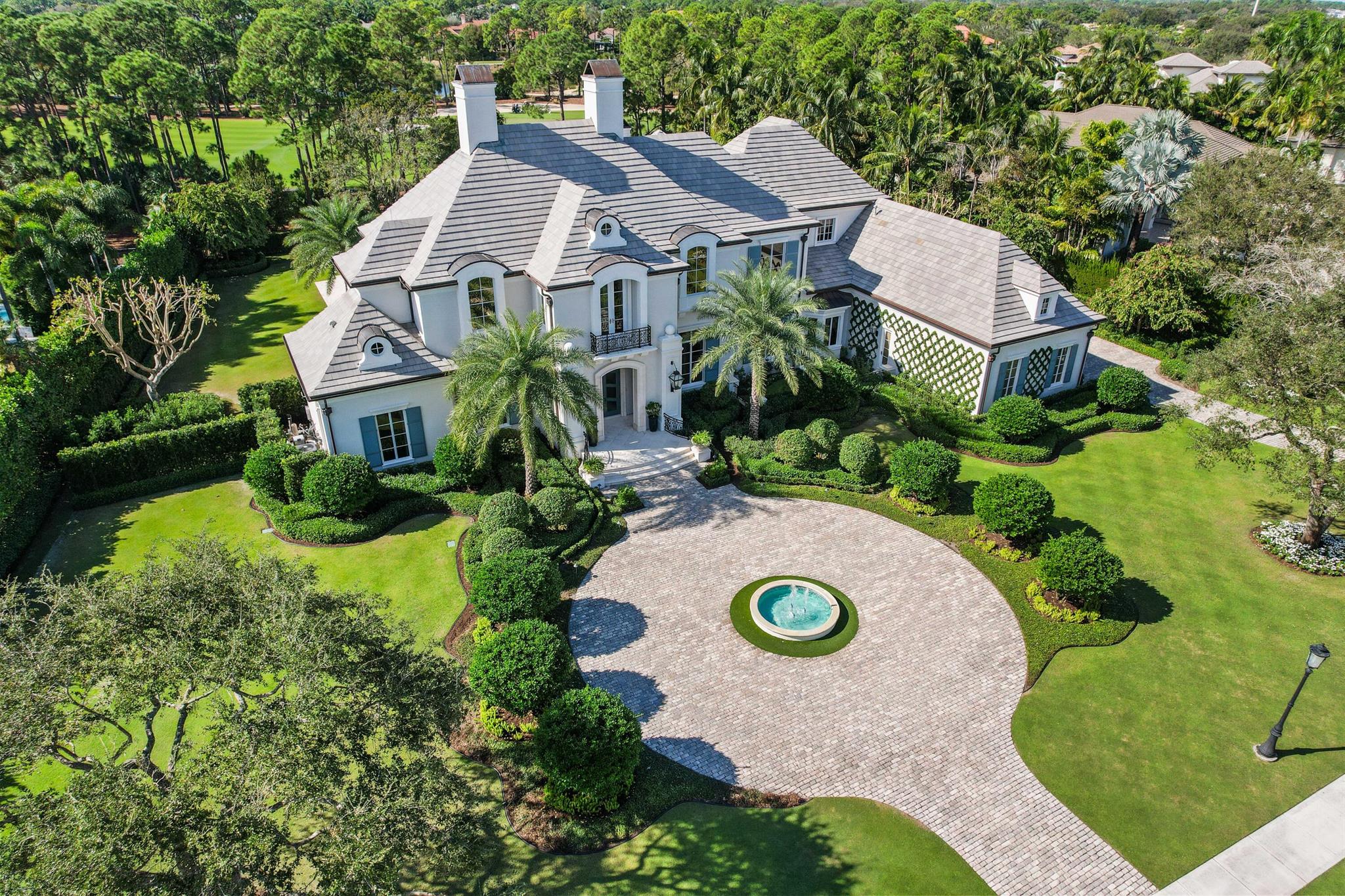 This stunning home, nestled on a 1-acre plot within the prestigious Old Palm Golf Club, emanates European elegance. Encompassing over 8000 sf, it features five bedrooms, including a spacious second floor primary suite with separate bath and dressing rooms, two offices, a temperature controlled wine room, elevator, attached guest house and a four-car garage. Meticulously detailed, the residence caters to the most discerning buyers who appreciate exquisite craftsmanship. Recent enhancements span electrical, audiovisual, and landscaping, elevating the home's allure. Beyond the confines of this luxurious abode, Old Palm Golf Club beckons with its renovated clubhouse, a new 20,000 sf. Lifestyle center, and top-notch amenities (two story fitness facility, four lane outdoor lap pool,