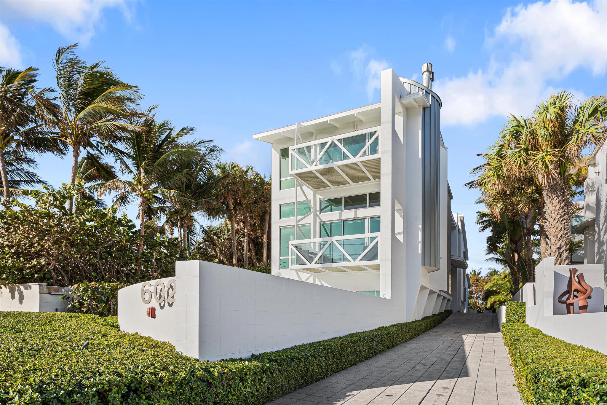 Architecturally brilliant and newly renovated, this ultra-luxurious tri-level residence combines panoramic ocean views with luxury, elegance and personal privacy. Details include a full-floor master suite, guesthouse, great room with sleek epicurean kitchen, media room with kitchenette and cabana bath, steel spiral staircases, elevator, and lap pool with water features. North Ocean Boulevard, Delray Beach, Florida. Historic Delray Beach is a beautifully preserved oceanfront community in the heart of South Florida's famed Gold Coast. Ensconced in an exclusive island-side enclave, this ultra-luxury residence is directly across the street from pristine ocean beachfront and within walking distance of the eclectic shops, cafes and restaurants that line vibrant Atlantic Avenue.

PROPERTY:
On a fenced quarter-acre, framed by specimen palms and manicured hedges, a brick motor court introduces this stunning contemporary estate delivering a distinct sense of place. In the newly landscaped backyard, covered and uncovered patios and the new outdoor kitchen offer ample spaces for entertaining. Custom-designed water elements include a covered heated lap pool flanked by a spa and a spillover waterfall, along with an outdoor shower, all recently updated.

RESIDENCE:
An architectural triumph that defines elegance, luxury and privacy, this artfully designed and recently renovated five-bedroom masterpiece, with 9197-¦ total square feet, encapsulates a striking industrial urban aesthetic with lyrical interior curves. Contrasting a dynamic, melodious fluidity and a sense of drama that surprise and delight from every vantage point, the three-story foyer and impressive glass-and-steel spiral staircase are crowned by a metal-clad ceiling. From the first-level, comprising a media room, with a kitchenette and cabana bath, and guest bedrooms with renovated ensuite bathrooms, the staircase ascends to the main floor. Showcasing a gas fireplace designed by Dominique Imbert, the chic great room opens to an oceanfront covered patio. Just adjacent, the formal dining area is served by a gourmet kitchen with glass-faced cabinetry and professional-grade stainless appliances. A hallway with glass-shelved built-in cabinetry is a prelude to the voluminous library, the steel spiral staircase to the third-floor, and an outdoor walkway to the private guesthouse with a sitting room and ensuite bedroom. A luxurious sanctuary, the magnificent primary suite occupies the entire third level. The expansive bedroom, with a sitting area is enhanced by a gas fireplace, a metal pitched ceiling, and aluminum shuttered sliding doors that access the oceanfront balcony. The suite comprises custom-fitted walk-in closets and a celadon-tiled bathroom with a black-accented dual-sink vanity, jetted spa tub and walk-in shower. Completing the layout are a laundry, industrial-style elevator with new technology, and  an airconditioned two-bay garage. New amenities include a full-house generator, security and camera systems, outdoor speakers, hurricane-rated glass, motorized shades, and two air-conditioning units, with all six equipped with expensive UV light purifiers and electric static air filters to insure the cleanest possible air throughout the home. With the serenity of seemingly endless ocean views and immediate entr+¬e to the beach, this ultra-contemporary residence and guesthouse embody the energy and ambiance so essential to an exceptional South Florida lifestyle. The creative use of spaces topped by volume ceilings, open galleries, an atrium, window-walls of glass, designer fireplaces, new wood and porcelain flooring, decorator-curated lighting and fiber-optic exterior lighting maximize the estate's emotional impact.

The information herein is deemed reliable and subject to errors, omissions or changes without notice.  The information has been derived from architectural plans or county records. Buyer should verify all measurements.

DISCLAIMER: Information published or otherwise provided by the listing company and its representatives including but not limited to prices, measurements, square footages, lot sizes, calculations, statistics, and videos are deemed reliable but are not guaranteed and are subject to errors, omissions or changes without notice. All such information should be independently verified by any prospective purchaser or seller. Parties should perform their own due diligence to verify such information prior to a sale or listing. Listing company expressly disclaims any warranty or representation regarding such information. Prices published are either list price, sold price, and/or last asking price. The listing company participates in the Multiple Listing Service and IDX. The properties published as listed and sold are not necessarily exclusive to listing company and may be listed or have sold with other members of the Multiple Listing Service. Transactions where listing company represented both buyers and sellers are calculated as two sales. The listing company's marketplace is all of the following: Vero Beach, Town of Orchid, Indian River Shores, Town of Palm Beach, West Palm Beach, Manalapan Beach, Point Manalapan, Hypoluxo Island, Ocean Ridge, Gulf Stream, Delray Beach, Highland Beach, Boca Raton, East Deerfield Beach, Hillsboro Beach, Hillsboro Shores, East Pompano Beach, Lighthouse Point, Sea Ranch Lakes and Fort Lauderdale. Cooperating brokers are advised that in the event of a Buyer default, no financial fee will be paid to a cooperating Broker on the Deposits retained by the Seller. No financial fees will be paid to any cooperating broker until title passes or upon actual commencement of a lease. Some affiliations may not be applicable to certain geographic areas. If your property is currently listed with another broker, please disregard any solicitation for services. Copyright 2022 by the listing company. All Rights Reserved.