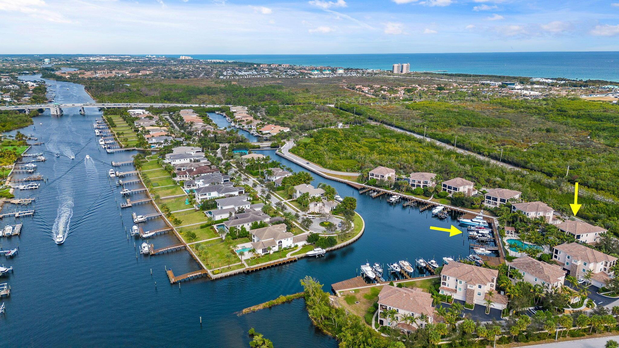 A luxury property in a premier location. Elegant 3-bedroom condo in exclusive Frenchman's Harbor. A gated, waterfront community, Frenchman's Harbor affords owners direct Intracoastal access, deep water slips, and no fixed bridges to the ocean. This property includes a deeded 45-foot boat slip for up to 60' vessel. The home itself features an efficient, airy floorplan with a large, open chef's kitchen. Wood floors, custom trim, custom built-ins, high ceilings, and appealing colors give this unit a bright, coastal feel. Oversized balcony offers canal, pool, Intracoastal and sunset views. The best of condo and single family living with a private 2 car garage and plenty of driveway space. Unit is accessible with staircase and elevator options. Full hurricane impact windows and doors.