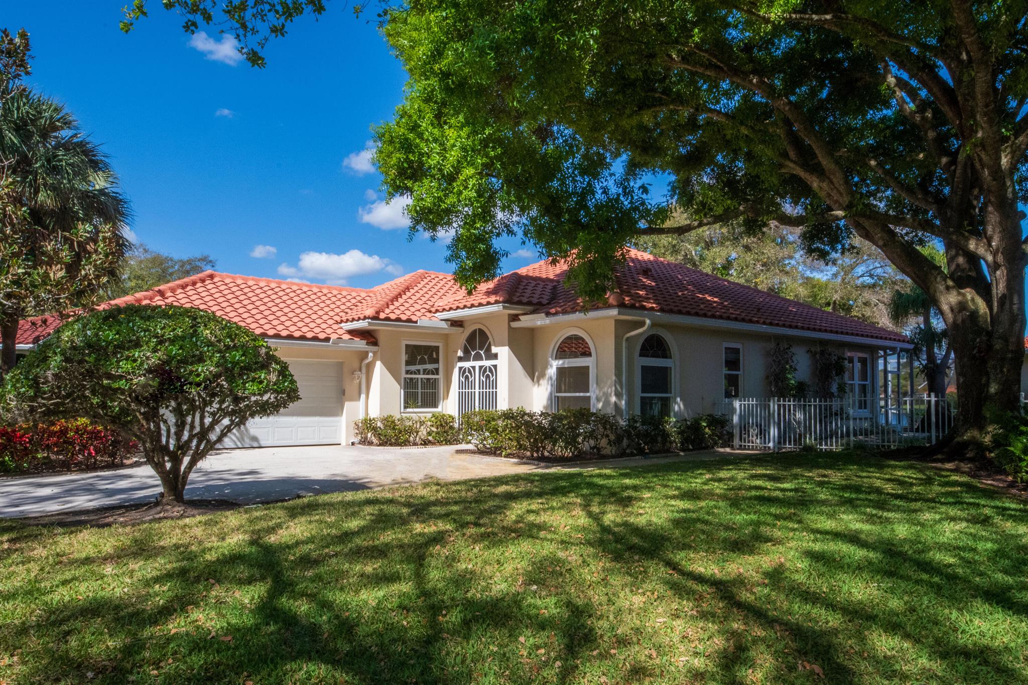 WOW FACTOR with magnificent water views PLUS an extra-large sideyard AND across the street from community pool (quintessential location within the location) PLUS extended model w/ 200+ sqft of space in the LivingRm/DiningRm area. Timeless updates w/classic Palm Beach meets European Design esthetic. This home also offers quality finishes & thoughtful touches throughout like the JenAir stove, Padron Tile, solid wood cabinetry, quartz & granite C-tops++U'll also appreciate the updated tile roof, 3 updated impact Skylights & gutters.Not to mention the Impact windows & doors throughout-Including the entire bank of back sliders highlighting the spacious brick paved & screen enclosed patio with INCREDIBLE WATER VIEWS from both inside & outside this very special home.10' Volume Ceilings & more+++