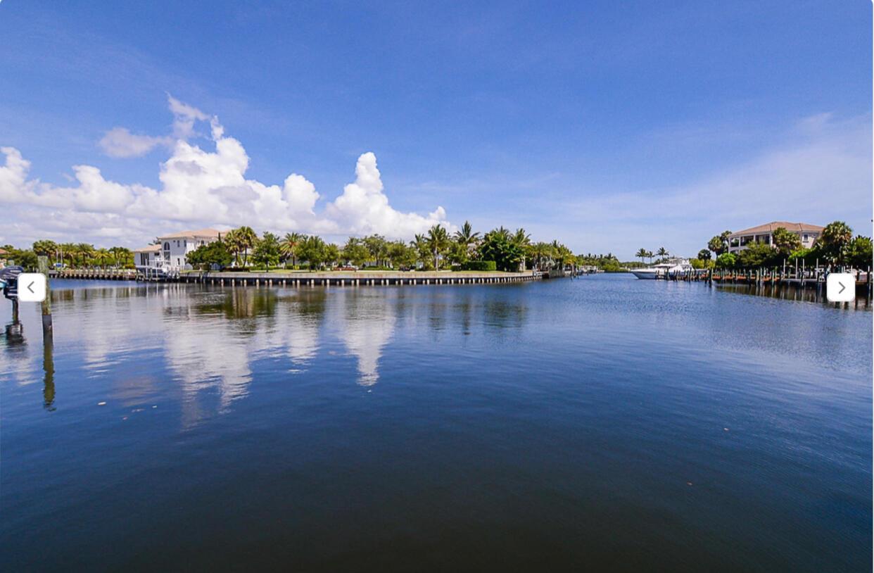 PANORAMIC INTRACOASTAL VIEWS. MODEL! Boaters dream. Bring your 65ft yacht and water toys to your own deeded dock in a safe deep water harbor. Experience the epitome of luxury in this modern Miami style retreat situated within the esteemed Frenchman Harbor gated community. This 3BR/2 BA condo has the allure of a single-family home. 2 car garage w/loads of storage. Open concept floor plan w/over 2000 sq/ft. Chefs kitchen boasts stainless steel appliances, quartz countertops, and custom cabinetry complemented by the rich elegance of real wood flooring throughout. Expansive primary suite offers a generously sized walk-in custom closet, lavish marble bath w/a frameless glass shower, freestanding bathtub, double vanities. 24-hour manned security, community pool/jacuzzi. Lift and jet ski lifts Close proximity to the Gardens Mall, restaurants and PBIA and just a mile from Juno  beach. This residence effortlessly combines luxury and coastal living. For added comfort, the property features phantom screens that withstand 100-mile-hour winds, ensuring both privacy and tranquility in this coastal modern oasis.