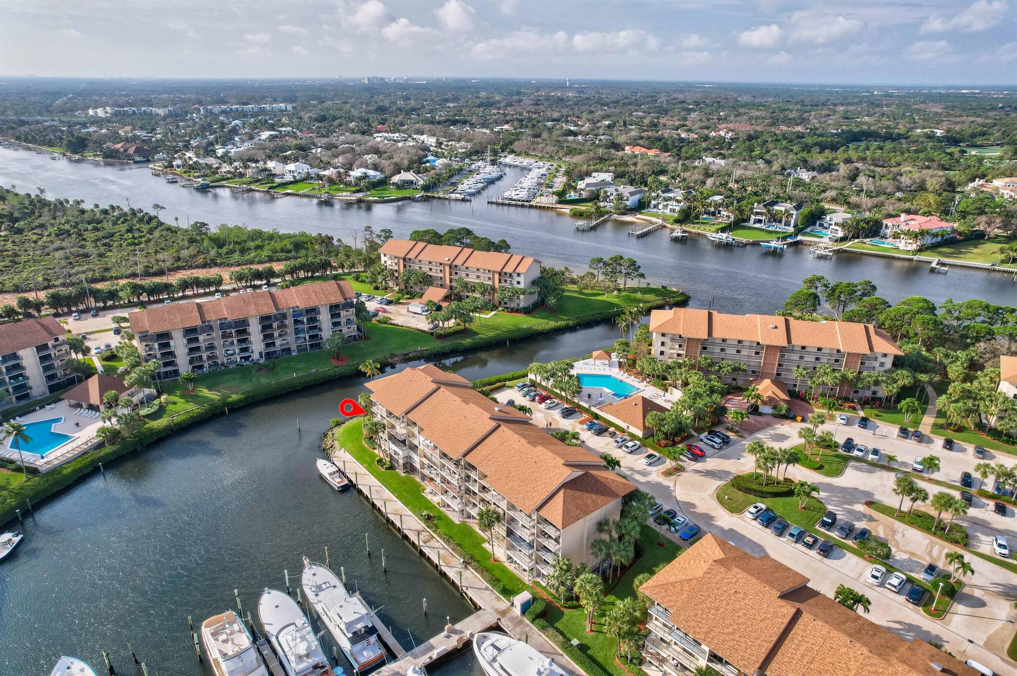 This two-bedroom, two-bath corner unit in the Bluffs, has been meticulously renovated and redefines coastal living.  This fourth-floor residence offers breathtaking views of the marina and intracoastal, seamlessly blending luxury and tranquility. Watch the beautiful sunrises from your waterfront balcony. The tasteful interior creates an inviting atmosphere with modern finishes and an abundance of natural light.  The updated kitchen has plenty of cabinets and storage, while the large laundry room has an extra room for an office and/or storage.  Each bedroom is situated for privacy, while the living area showcases the scenic beauty just beyond the windows. This resort style community offers swimming pools, tennis courts, bocce ball, barbeque areas, on-site security and minutes to the beach and dog park.  This residence is a true gem, embodying the essence of waterfront living at its finest!   One Pet allowed under 20 pounds and Rentals after 1 Year.