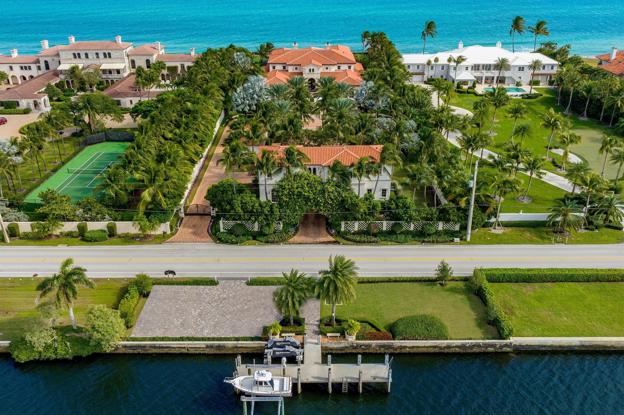 Spectacular Ocean-to-Lake Light and Bright Modern Mediterranean Compound with 9BR/11.3BA and 150 feet +/- of Ocean and Intracoastal frontage. This one-of-a-kind estate features rich details, intricate millwork, and sophisticated finishes. From spectacular reception to oversized living spaces and gorgeous formal dining room, this home is perfect for entertaining. Stunning wrought iron entryway opens to welcoming foyer with sweeping, detailed ceilings, beautiful imperial staircase, and crystal chandelier. Pristine estate with great natural sunlight throughout. Eat-in kitchen with island, china and silverware closet, and butler's pantry. Fabulous theater room connects to pub room with full bar. Paneled library with detailed fireplace. Expansive second floor primary wing with fireplace, dual baths, walk-in closets, and striking ocean views. Finished basement features air-conditioned 12+ car garage and temperature-controlled wine cellar with wet bar and tasting table. Fantastic guest house with two bedrooms, kitchenette, washer and dryer, and elevator. Full staff house with two bedrooms and kitchen. Deep water concrete dock. Oversized oceanfront columned loggia with summer kitchen, al fresco dining, TV, and fireplace. With covered balcony, open balcony, fountain, and pool, this Estate is perfect for outdoor living.