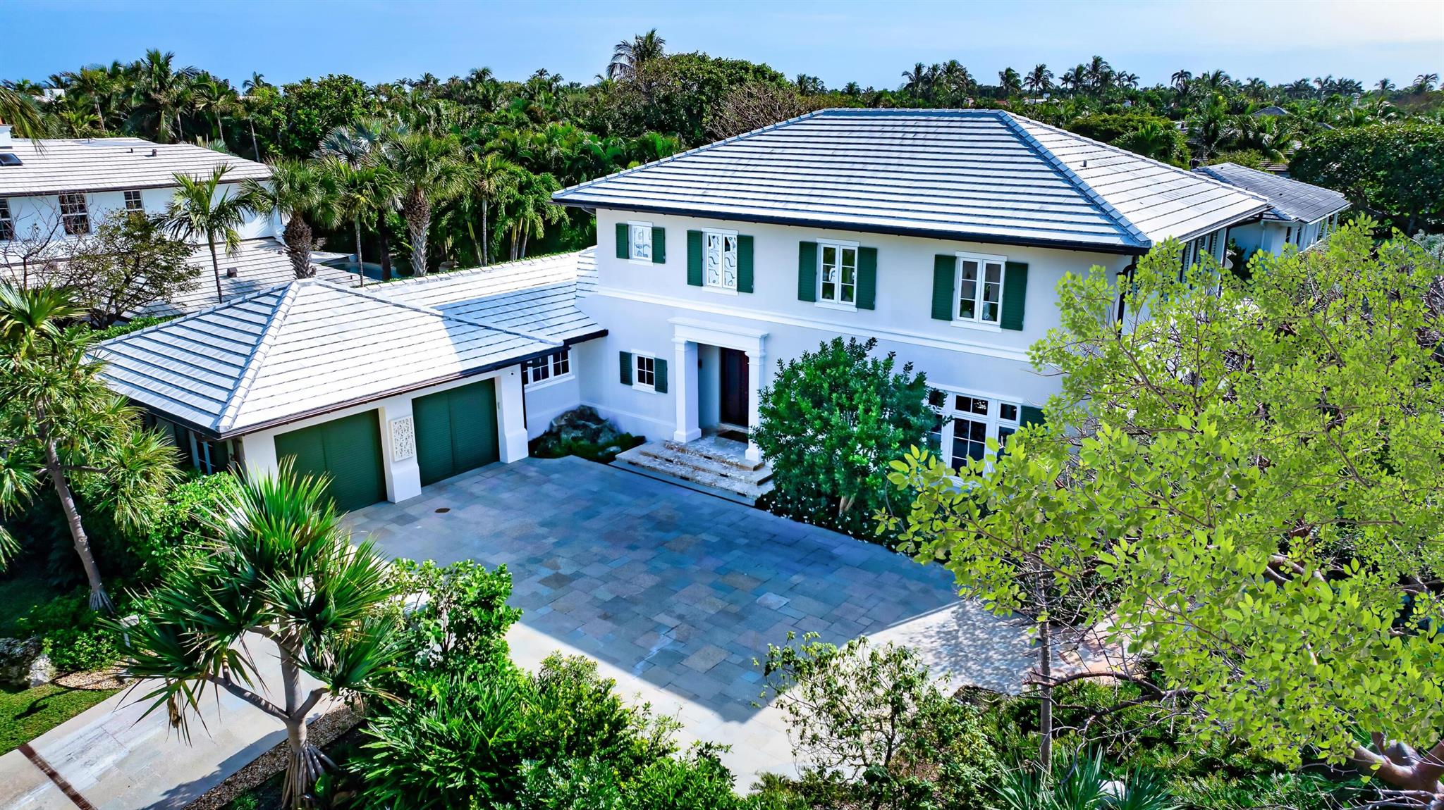 Welcome to 1333 N Lake Way & 250 Angler Ave, an exceptional multi-structure compound on the North End of Palm Beach Island. This rare assemblage of just under an acre on a coveted beach cabana street features 2 private homes with 2 gorgeous kitchens, a total of 7 bedrooms, over 8,200 square feet of total living space, a beautifully curated landscape, an oversized 75' heated lap pool, an extra-large yard in the Southeast corner of the property, and garages for 4 cars. The unique estate, sitting on a 37,000+/- square foot lot, provides discerning buyers with widespread opportunities to either move right in and enjoy, or to build a new legacy, generational compound which can ultimately accommodate up to 3 different structures - such as a main house, guest house, and pool cabana. In addition to being next door to the prestigious Sailfish Club of Florida, the home includes deeded access to the pristine beaches of the Island's North End, both through access on Angler as well as through the shared private cabana of Ocean Terrace. The property also boasts easy access to the popular Lake Trail.  While being a peaceful retreat and calm oasis from all the Island's action, the drive to the town is just about 10 minutes or less, providing convenient access to the full array of amenities which Palm Beach has to offer.  Offered exclusively at $29,950,000.