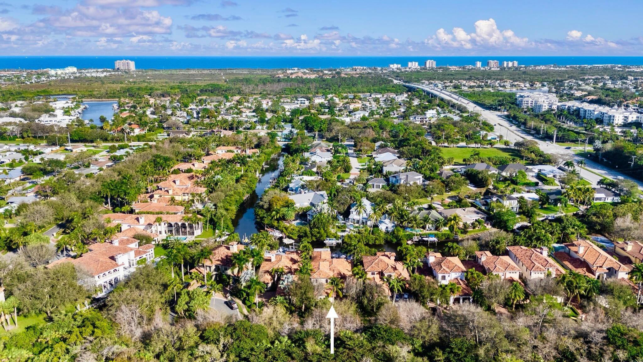 This updated waterfront home is located in The Cove, a waterfront community within a gated enclave just minutes from the Beach. It is situated next to the Bears club and across from Frenchmans Creek, offering a tranquil lifestyle along a picturesque navigable canal, adjacent to the main Intrascoastal.&#8232;&#8232;The home boasts nearly 4,000 square feet of living space, featuring a first-floor primary bedroom and a guest bedroom. With a total of four bedrooms, a den, and 4.5 baths, as well as a 2-car garage, there is plenty of space. Inside and out, the property showcases stunning upgrades, including marble and wood flooring in the main living areas. All windows and doors are high impact resistant for peace of mind.&#8232;&#8232;The custom kitchen is a true masterpiece, equipped with a sp impact resistant for your peace of mind.

The custom kitchen is a true masterpiece with a spacious center island, quartz countertops, a 6-burner gas cooktop, and a 48" refrigerator. Outdoor living is equally impressive, with a summer kitchen featuring a stainless steel barbecue, perfect for entertaining. The primary bedroom offers an updated bathroom and three walk-in closets. The property also offers a beautiful custom heated pool, spa, two covered lanais, and expansive patios for relaxation.

Water enthusiasts will appreciate the private dock, which includes a 6,000 lb electronic boat lift and a floating platform for easy canal access. Additional features of this exceptional property include Phantom screens for insect-free outdoor enjoyment, whole-home reverse osmosis for purified water, an electric fireplace in the owner's suite, and the living room. Furthermore, the house is equipped with a whole house generator. Three brand new HVAC systems have been installed
