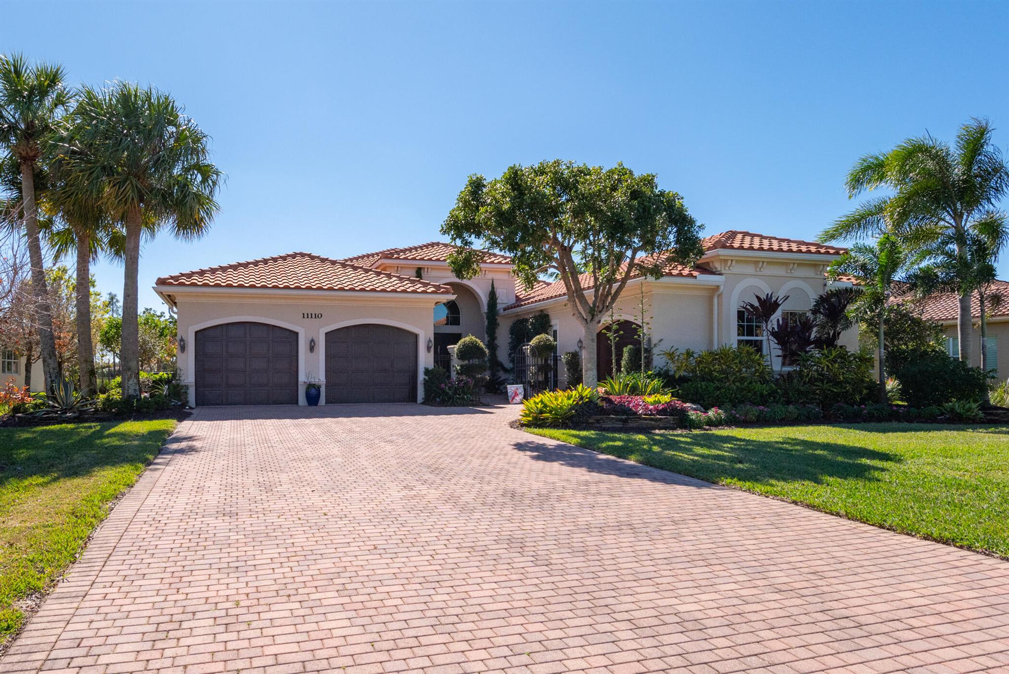 Long sparkling lake views from this beautiful 3BR/3.5BA Plus Club Room home set on a half-acre lot in Palm Beach Gardens! Enjoy the southern exposure and warm Florida breezes relaxing by the screen enclosed pool and extended lanai. This popular Magnolia Model was built in 2014 by GL Homes and features FULL IMPACT WINDOWS and DOORS, a THREE CAR GARAGE, large 24X24 Polished Porcelain tile in the main living areas and bamboo wood floors in the primary suite. Recent updating to the home includes NEW A/C SYSTEM, new front-loading LG Washer/Dryer, new dishwasher, new pool pump and lush landscaping on this outstanding waterfront lot. Very peaceful manned gated community with very low HOA Fees, tennis/pickleball court, basketball court, playground and sports field for the whole family to enjoy!!
