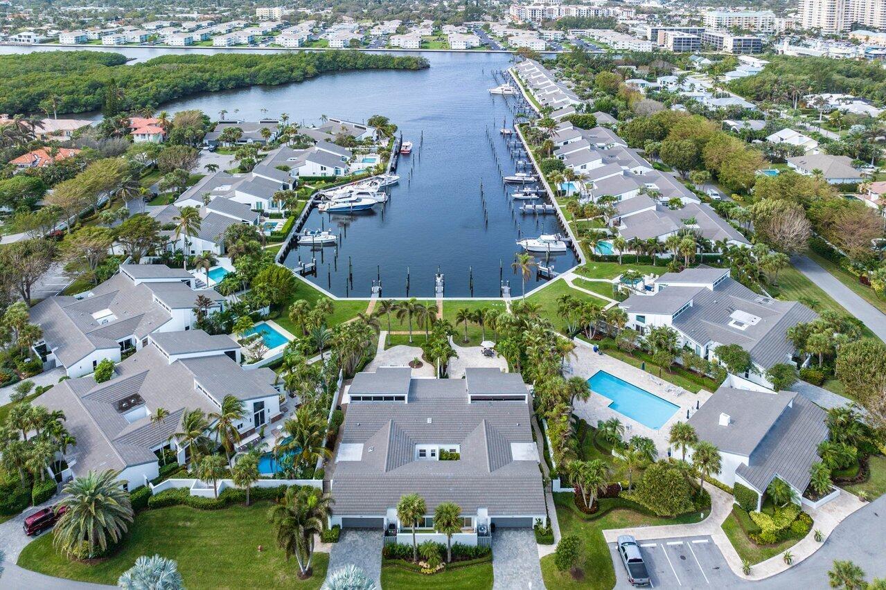 Welcome to the epitome of upscale waterfront living at Pelican Cove in Ocean Ridge. This premier central location within the community offers a small boutique setting of just 40 homeowners, creating a sense of exclusivity and privacy. Situated on the intercoastal, this property boasts breathtaking East-West views of the fantastic sunset over the water lagoon. One of the highlights of this home is the Florida room, which provides a direct view of the water and an impressive extended dock- up to a 60-foot Yacht. Imagine sipping your morning coffee or evening cocktail in this tranquil setting, accompanied by the soothing sounds of the intercoastal. The dock and the 2500 square feet oasis surrounding it are adorned with marbled travertine pavers, creating an elegant and stylish outdoor space. The patio also has a top-of-the-line sound system, perfect for entertaining or relaxing in your paradise.

Inside the 2800 square-foot home, you'll find move-in ready features that have been thoughtfully designed and meticulously maintained. The open remodel showcases a stunning kitchen with tea-green granite countertops, an island, and a wet bar. The kitchen seamlessly integrates with the granite, earth-edge fireplace, creating a harmonious and inviting atmosphere. High-end amenities include a sub-zero wine cooler and more relaxed, luxurious cherrywood recessed cabinets with stained glass and lighting.

As you explore further, you'll notice the natural beauty of the oak floors, which extend throughout the living room, foyer, entertainment center, home office, and even the closets. The spacious layout encompasses a large great room with a living room, dining room, and kitchen, all bathed in abundant natural light. The property features two separate air conditioning units with UV lamps and purifiers, ensuring a comfortable and healthy living environment. For added security and convenience, the home has a touchpad security system strategically positioned directly to the Ocean Ridge Police Department.

In addition to the stunning interior, this property offers various outdoor amenities for your enjoyment. You'll find a three-hole putting range outside the guest bedroom, perfect for honing your golf skills. A separate atrium is dedicated to nurturing plants and flowers, adding a touch of nature to your everyday life. A large renovated laundry room away from the main living area, making household chores a breeze. The entertainment area and primary bathroom are flooded with natural light, creating a serene and inviting space.

Pelican Cove, a Gated Community, is committed to preserving the beauty of its surroundings, devoting a third of its property to lush landscaping. With over 1000 palm trees, the community offers a tropical ambiance that is well-maintained and updated. The seawall has been recently renovated, and the saltwater pool is an inviting oasis for relaxation and recreation. The health and community center is just steps from your home, providing convenient access to fitness facilities and community events.

Additional upgrades include a new roof in 2020, freshly painted exteriors, and well-maintained walkways and driveways. This property truly offers an exceptional waterfront lifestyle in a prime location. Take advantage of the opportunity to make this your own luxurious retreat in the coveted Ocean Ridge. From Vero to Miami Beach, Pelican Cove is unique!