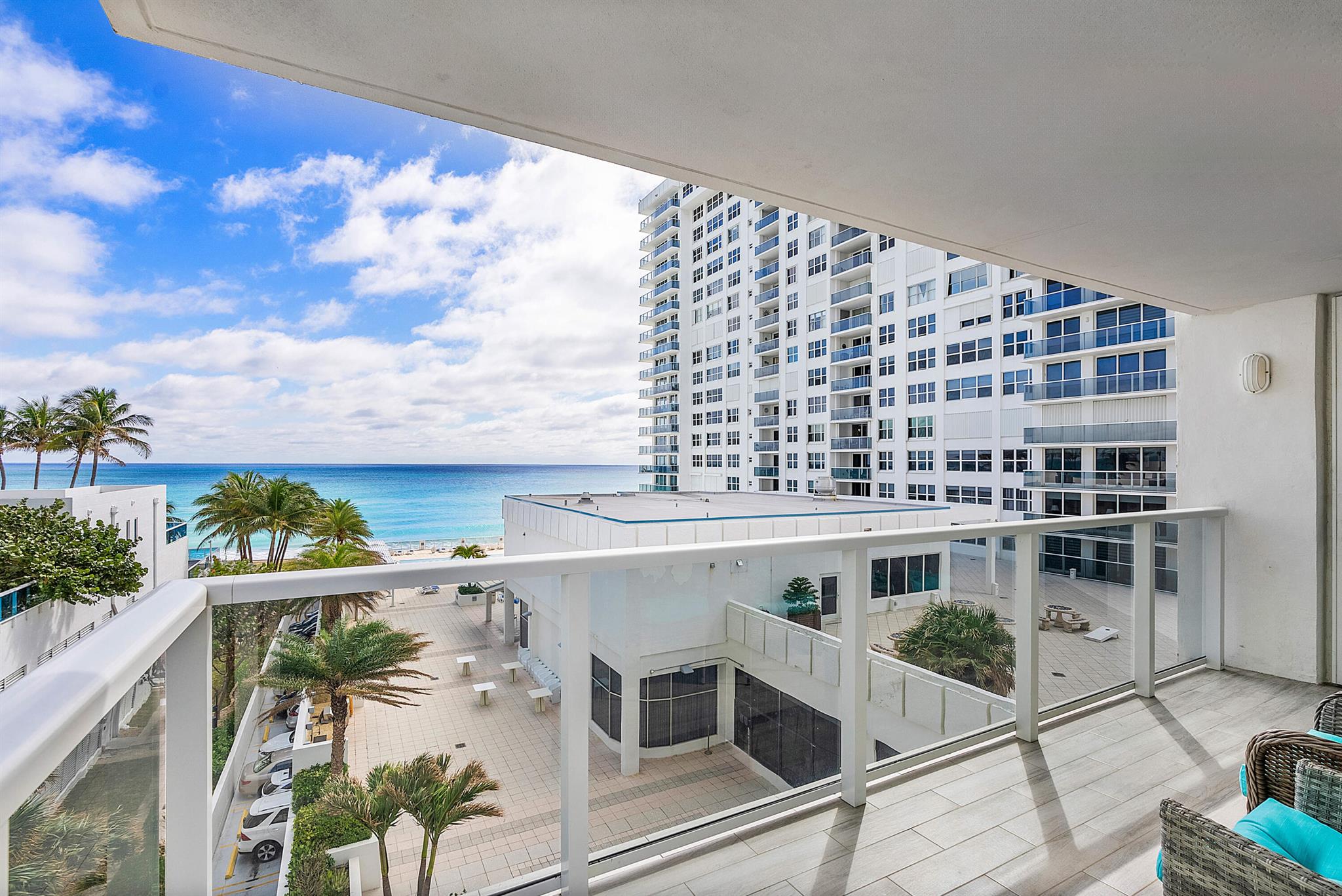 Discover unparalleled coastal living in this magnificent oceanfront furnished 2-bedroom, 2-bathroom condo at The Aquarius. Offering direct and uninterrupted ocean views, this residence stands out as one of the largest units in the community. Boasting brand new HVAC, newer (2022) upgraded hurricane impact windows, step onto the expansive wrap-around balcony to be greeted by ocean waves and serene views.  Revel in the lavishness of marble-adorned bathrooms and floors that elevate the aesthetic of this already spacious and inviting home. Included with this coastal gem is a garage space and additional storage, ensuring convenience and ease in your daily life.Immerse yourself in resort-like living with a wealth of amenities at your fingertips. Enjoy leisurely afternoons host gathering in the inviting grill and entertaining space, challenge friends to games in the well-equipped game room, stay fit in the large gym, and conduct business or events in the convenient meeting rooms. The on-site restaurant completes the experience, providing a culinary delight without leaving the comfort of your oceanfront retreat. This condo is not just a home; it's an invitation to embrace a lifestyle where luxury, comfort, and natural beauty seamlessly converge in a community designed for the ultimate coastal experience.