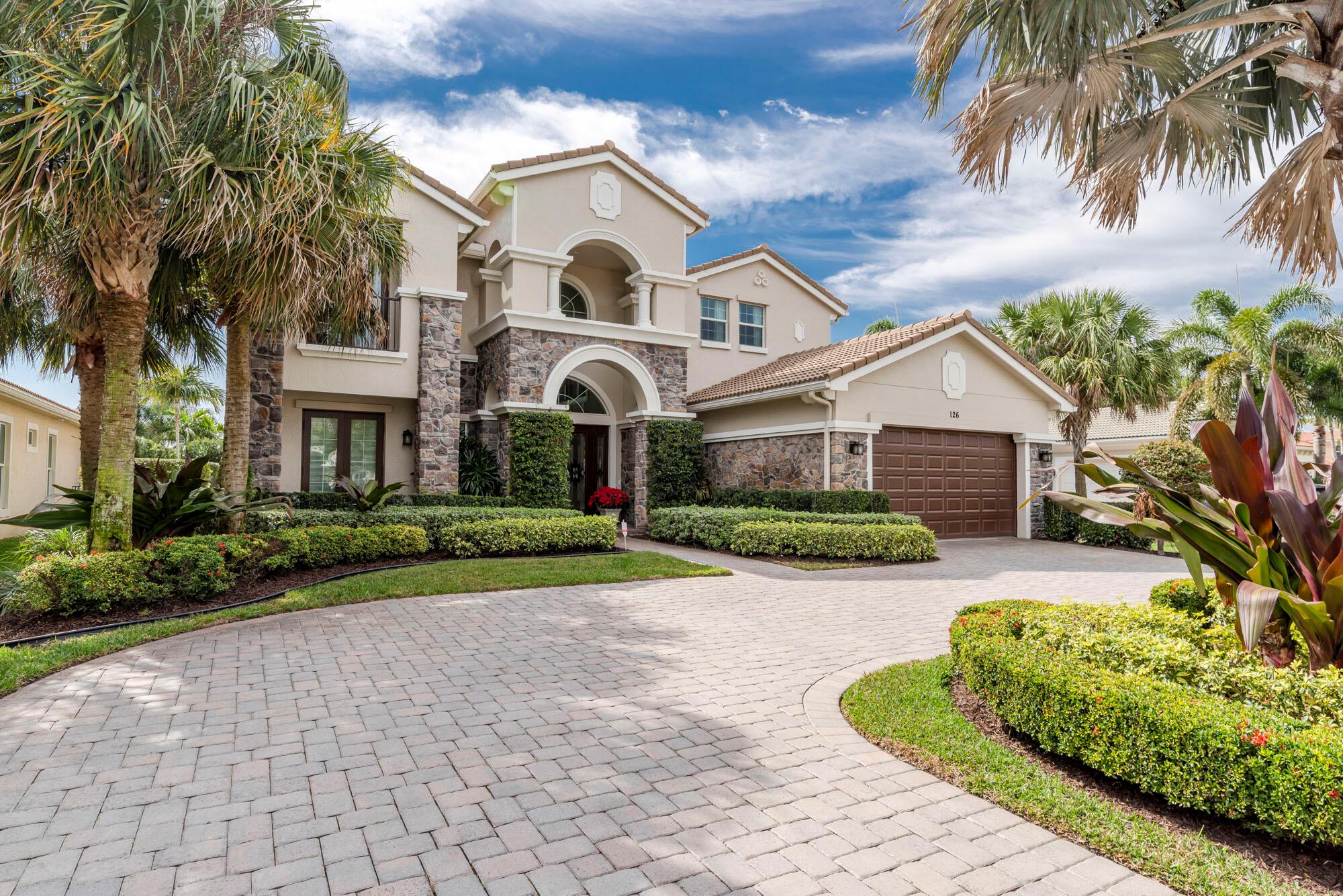 Step into luxury and sophistication as you enter this exquisite Grand Estate home, where open spaces and lavish details merge seamlessly. A grand double-door entrance welcomes you into a 2-story foyer adorned with a graceful circular staircase, setting the tone for the elegance that awaits. Your gaze is drawn to the inviting formal living room, boasting a charming fireplace and floor-to-ceiling windows that flood the space with natural light. Adjacent is the dining room, adorned with a coffered ceiling, providing a perfect setting for intimate gatherings and culinary delights. Crafted by a top interior designer, this custom home boasts impeccable attention to detail, featuring marble and wood flooring, exquisite craftsman woodwork, and the finest design finishes throughout. The kitchen is a culinary masterpiece, equipped with top-of-the-line FULGOR MILANO gas stove, dishwasher, and double oven. The family room, seamlessly integrated with the kitchen and separate breakfast area, offers breathtaking views of the covered lanai, beckoning you to unwind and enjoy the tranquility of the outdoors.
The Treanna floorplan elevates luxury living to new heights, with the primary bedroom suite located upstairs. Retreat to your private sanctuary, complete with a serene balcony, two spacious walk-in closets, and a lavish primary bath featuring his and hers vanities, a Roman tub, and a separate shower. An open second-floor loft overlooks the living room and foyer below, leading to a bridge connecting three additional bedrooms and two full baths.
A private downstairs wing offers two guest bedrooms and a fourth full bath, ensuring comfort and privacy for guests or family members. The den/office, adorned with built-ins, provides the perfect space for work or relaxation. Additional amenities include a convenient cabana bath, separate laundry room, and a three-car tandem garage.
Outside, indulge in the ultimate outdoor living experience with a sprawling kitchen and bar area, ideal for entertaining guests amidst the serene ambiance. Take a refreshing dip in the sparkling blue pool, complete with captivating water features reminiscent of a tropical paradise. Surrounded by lush landscaping and a fully fenced perimeter, this backyard sanctuary offers complete seclusion and privacy.
This home comes with a Golf Membership.
Enjoy exclusive access to the renowned Jupiter Country Club, boasting Greg Norman golf and resort amenities such as tennis courts, pickleball, pools, fitness center, bocce, and dining options. Embrace the active lifestyle set amidst a certified Audubon preserve, with easy access to I-95 and Florida's Turnpike, and just a short drive to Palm Beach International Airport and Jupiter's pristine beaches, fine dining, shopping, and endless recreational activities. Experience the epitome of luxury living at its finest in Jupiter Country Club.