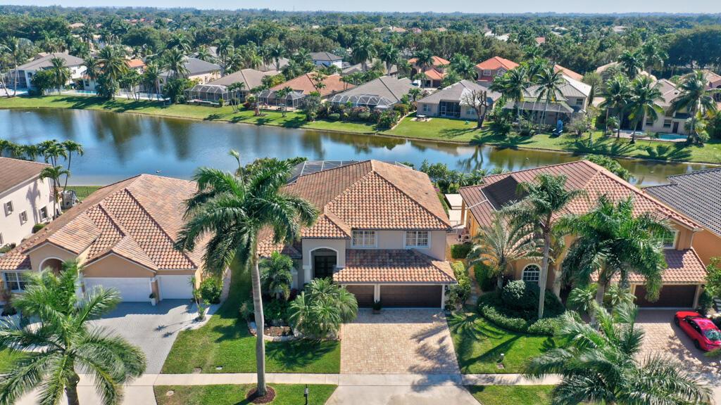 Totally updated waterfront home in the Resort style community of Boca Falls.  Roof New in 2018. Kitchen features double ovens, large island & beverage bar with open concept to family room.  Luxurious first floor primary bedroom with direct access to pool. Primary bathroom fully renovated with designer cabinets, quartz counter tops, free standing tub & separate large shower. Family room features a built-in electric fireplace & volume ceiling.  Upstairs features a loft with two built in workstations, 2 bedrooms & luxury bathroom.  Back yard is appointed with a resort style pool area with an outdoor kitchen & amazing waterfront view. Boca Falls has its own private entrance to ''A'' rated Waters Edge Elementary.  Community features manned gated entry, resort style pool, clubhouse & Gym.