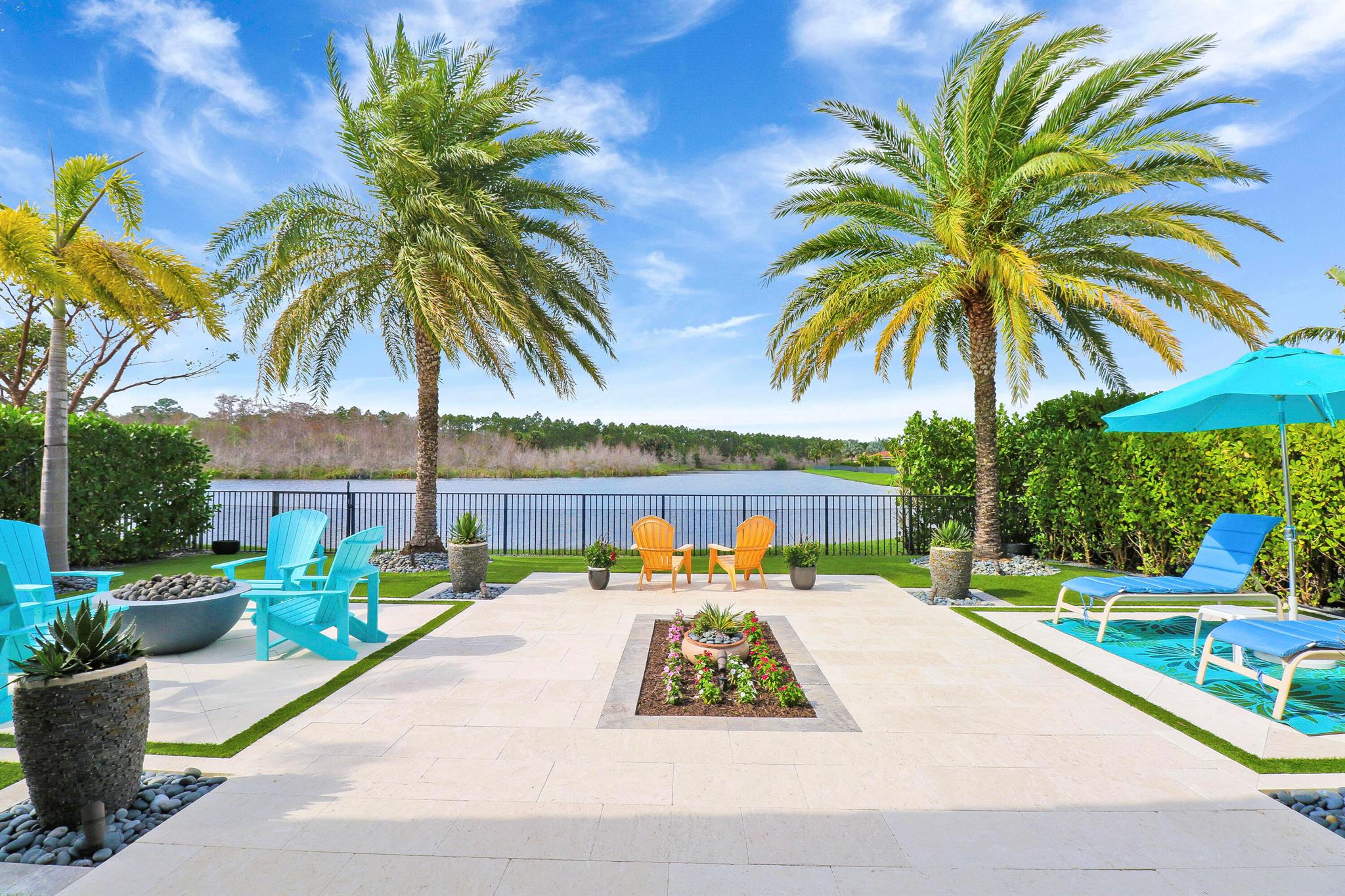 Welcome to your lakeside paradise in Jupiter Country Club. This stunning Saranac model by Toll Brothers offers a tranquil retreat with breathtaking views of the lake and Riverbend Park. Built in 2014, this home boasts 3 bedrooms, 2 1/2 bathrooms, and a den/office (or optional bedroom), providing ample space for comfortable living.  From the moment you open the front door, you are captivated by the views that are second to none!  Enjoy a spacious home with tons of natural sunlight, creating a perfect setting for relaxation and entertainment. The well-appointed kitchen features a huge granite island, gas range, tons of storage, full pantry, dining room and more, making it ideal for both everyday living and hosting guests.You will spend your days outside enjoying the relaxing well-thought out space! The patio and back yard are an absolute paradise, featuring travertine decking with turf, tropical landscaping, a fire pit, and multiple seating areas. The patio also boasts tongue and groove ceilings, a motorized screen, giving you the ability to open the space completely when desired. The private back yard and large side yard are fully fenced to offer a sense of seclusion and security. 

Additional features include impact glass, a new AC (2024), freshly painted exterior, and an air-conditioned garage with split AC and extra storage. The home also boasts a new hot water heater, making it move-in ready for its new owners.

With its serene setting and modern comforts, this home is perfect for those seeking a lock-and-leave lifestyle or a peaceful full-time residence. Don't miss the opportunity to make this home your own.

Jupiter Country Club is a luxurious private country club offering world-class amenities and an exclusive community of single-family homes and carriage homes. The Grand Clubhouse is a magnificent hub of activity, featuring impressive on-site dining and entertainment, bocce ball courts, fully stocked men's and women's locker rooms, as well as a golf shop for enthusiasts. For fitness enthusiasts, the Sports Club is a state-of-the-art facility equipped with everything needed to achieve your fitness goals. From free weights to cardio equipment, tennis, Pickleball, and multi-purpose sports courts, this facility offers a comprehensive range of options to cater to all fitness preferences. There are 2 pools and a Childrens playground.  The community has a 24 hour manned gate and roving security.  It is conveniently located just minutes to I95 and the Turnpike, as well as, a plethora of shops, dining and entertainment.