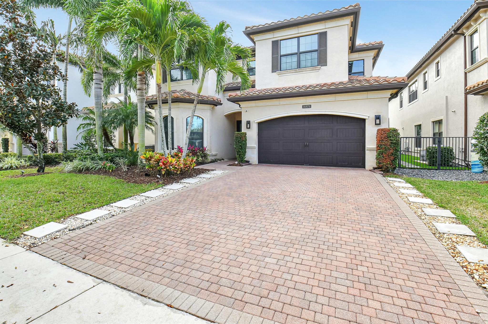 Welcome to luxurious living at its best in Delray Beach, Florida's coveted Bridges community! This stunning newer Manchester Model home boasts 5 spacious bedrooms, 5 baths, plus a large loft. With over 4,000 living sq feet and a total of 5,069 total sq feet this home will accommodate even the largest of families. Step inside to discover a beautifully appointed interior featuring high-end finishes and designer touches throughout. The open-concept floor plan seamlessly connects the gourmet kitchen (gas cooking) complete with top-of-the-line appliances and ample storage, to the elegant dining area and inviting living space. No expense has been spared by the current owner and features include built-ins, fireplace, wood and tile floors throughout and motorized outdoor screens so you can