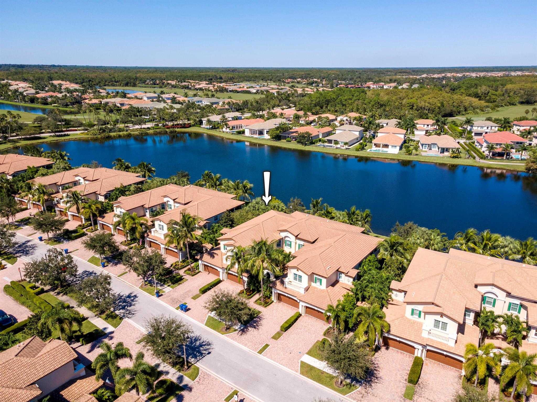 Breathtaking lake views from this prime waterfront location can be yours from this sought-after Genova model in the resort-style gated community of Jupiter Country Club. With nearly 2,700 sf of living area, this light-filled 3 bedroom, 3 bath PLUS den, 2 car garage carriage home lives like a single family home with the benefits of maintenance-free living. This well-designed floor plan offers open concept living with the living room adjacent to the kitchen & dining room. The kitchen is the heart of the home and features solid wood white cabinetry, beautiful granite countertops & a center island with stylish pendant lighting. The primary bedroom is spacious with a private door leading to the balcony, a large walk-in closet & a spa-like bath with a large soaking tub, dual vanities, and walk- in shower with frameless glass enclosure. Both guest bedrooms are ample in size - one guest room has an ensuite bath. The flex space/den is perfect as an office or TV room. The private electromechanical elevator was installed in 2016. Sip morning coffee or dine alfresco from the oversized screen-enclosed covered balcony with tranquil views of the wide lake and tropical landscaping. Live comfortably in this energy efficient home with CBS construction, impact glass and natural gas. Jupiter Country Club offers a luxury lifestyle with world-class amenities. It is a private gated community conveniently located within close proximity of I-95 and the FL Turnpike, beaches, shopping, restaurants, parks &amp; nature preserves. Club amenities include a Greg Norman designed golf course, 2 resort-style pools, the newly remodeled Sway restaurant, a state-of-the-art fitness center + group fitness studios (yoga, mat pilates, barre, spin &amp; more), tennis, pickle ball, bocce ball &amp; basketball. Jupiter Country Club is located in the highly desired Northern Palm Beach County and is the perfect location to easily access the surrounding cities of Orlando, West Palm Beach and Miami which provide a wealth of activities, culture and amenities. Live your best life here!