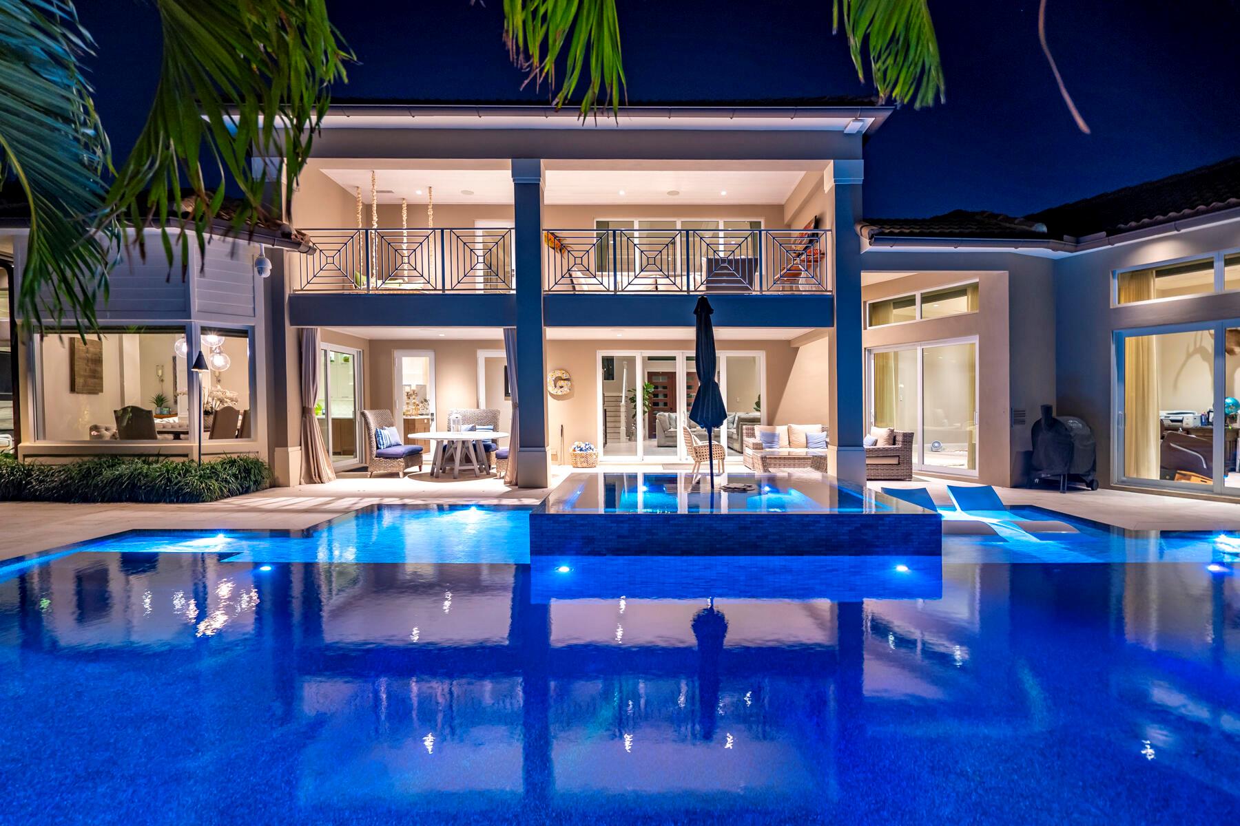 Experience unmatched elegance and modern sophistication at this waterfront estate fully renovated in 2019. This property epitomizes luxury living, offering a seamless blend of comfort, quality, and beauty. Positioned in an esteemed locale, it promises an exceptional lifestyle with stunning views and direct access to the water. Nestled in the sought-after Yacht Harbor Manor, Singer Island is renowned for its pristine beaches, lifestyle, and close proximity to diverse dining, shopping, and entertainment venues. This home stands as a beacon of unparalleled living in one of Florida's most prestigious communities. The residence welcomes you with a spacious design that includes 4 bedrooms and 4.5 bathrooms, all with copper plumbing throughout the home.  Each space is meticulously crafted, featuring Trimless AC grills, Trimless recessed High Hats, a Chandelier lift and strategically placed outlets in the baseboards for a sleek look.  The warmth and elegance of hardwood bamboo flooring flow throughout the home, enhancing the inviting ambiance.

Kitchen: Designed for the culinary enthusiast, the kitchen is equipped with Downsview cabinets, commercial-grade gas Wolf double ovens, high-end appliances, a water softener, and a generous walk-in pantry, setting the stage for gourmet creations and gatherings.

Smart Home Technology: The residence is outfitted with a cutting-edge Lutron electrical system and automated shades, alongside a high-grade security system, ensuring convenience and safety.

Boating: Offering 140 feet of prime waterfront and a new 120-foot dock with two boat lifts. The first is an elevator lift capable of holding 25,000 lbs as well as a 20,000 lbs lift, this estate is a nautical haven. It accommodates up to an 85-foot vessel, providing swift access to the intracoastal waterway and the Port of Palm Beach, all without the hindrance of fixed bridges.

Power Resilience: A robust 38k backup generator, equipped with a 400 amp ATS surge protector, ensuring comfort, security and continuous power if there ever is an outage.

Infinity Pool: The newly installed in-ground pool features an infinity edge and Coastal Source LED lighting, nestled within exotic landscaping for a secluded retreat. There is added extra safety with a sliding aluminum fence seperating the backyard and the dock. 

Tropical Landscaping: Lush tropical flora and a Coastal Source outdoor sound system envelop the property, crafting a peaceful, picturesque haven that enhances its waterfront charm.

1140 Powell Drive transcends the typical home, offering a lifestyle steeped in luxury, with its extensive renovations, premium amenities, and exceptional waterfront position. It's a place where every detail caters to your utmost comfort and desire, whether you're luxuriating indoors, embracing the aquatic lifestyle, or hosting in grand style.