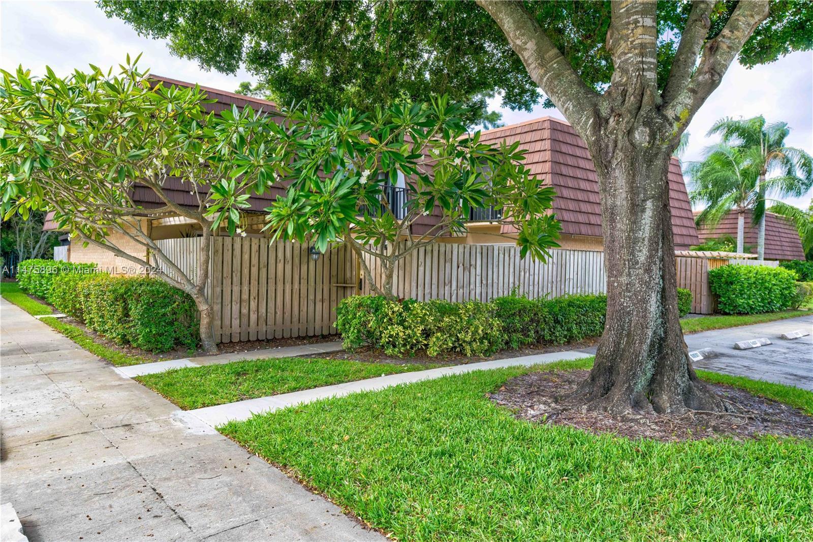 Prime NE exposure Garden Lakes, TH w/shady oak tree outside fenced courtyard area. All 5 sliding glass doors are PGT impact sliders making hurricane prep easy & also block most outside noise. Concrete DiVosta built w/3rd BR or den downstairs. New A/C 2021, gas water heater 2021, DW 2023, freshly painted interior, 2 new toilets, new carpet on stairs/upstairs & more! 2 assigned parking spaces right by courtyard gate & lots of guest parking available by unit. Covered veranda area & oversized storage area in courtyard. Granite countertops in kitchen, Large tile, move in ready w/neutral colors. Tucked away in popular PBG Garden Lakes community, but close to shops, restaurants, North County Park, I-95/Turnpike. Pet friendly & low HOA dues. Community amenities very close by.
