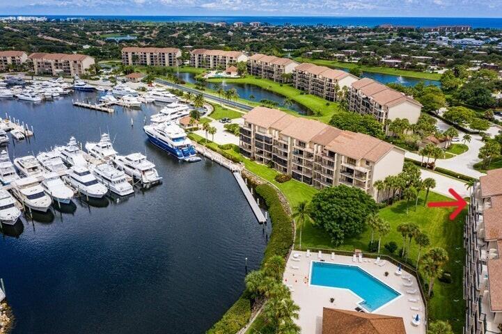 Indulge in coastal luxury with this upgraded two-bedroom, two-bathroom, end unit condominium, offering stunning marina views from your Large Private Balcony. Entertain effortlessly in the spacious Living Area, Dining Area, and Breakfast Bar. A bonus room adds versatility for storage, office, or guest space. Relax in one of the four pool areas with pavilions or enjoy active days on the resurfaced tennis/pickleball courts. Serenity awaits with lush landscaping and winding sidewalks offering water vistas. Just minutes from Jupiter's pristine beaches, Juno Pier, Harborside, and the Inlet, this is your Jupiter paradise.