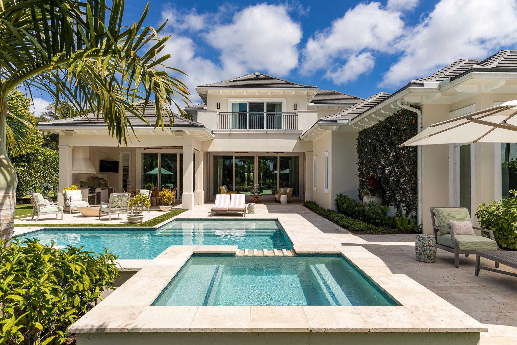 Spectacular 2 story British West Indies style estate in Old Palm Golf Club. Situated on a 1/2-acre lot with stunning views of the golf course. Located on Plantation Way, where homes rarely come on the market, this home was completed in 2017 and redesigned in 2022 with high-end interior design by Andrew Howard. Spread over 7,626 total square feet with high ceilings throughout, the home offers 4 bedrooms, 5 bathrooms, 2 powder rooms, an expansive great room, dining room with built-in wine fridge, family room, office/library, elevator and fabulous eat-in kitchen all in a free-flowing open concept design. The 3 car garage with additional golf cart garage entrance provides ample space for all of your storage needs. The gourmet kitchen features double 10ft islands, Cristallo Quartz countertops, and Wolf SubZero and Bosch appliances. The serene and peaceful primary suite is exquisite! It features an expansive bedroom with 12ft ceilings and sitting area that opens to the pool and spa. His and Her luxury bathrooms and closets are a highlight of the home!
This is an entertainer's dream - spacious covered loggia with new summer kitchen, pizza oven, Lynx Grill, refrigerator drawers, pool, spa, large pool deck, gas fire pit and exquisite sunset views from the expansive pool deck. Some of the state-of-the-art features include a Savant home automation and lighting control system, whole house water filtration system and new pool equipment.
The 650-acre Old Palm Golf Club, known for its Raymond Floyd designed course, has been recently updated with a new clubhouse, Bistro restaurant and 20,000 SF lifestyle center which includes spa, fitness facility, lap pool, 3-hole practice studio, kid's club and caf+¬. In addition, there are 1 BR guest casitas available and beach club membership at the Hilton on Singer Island. Experience luxurious living that Old Palm provides.
