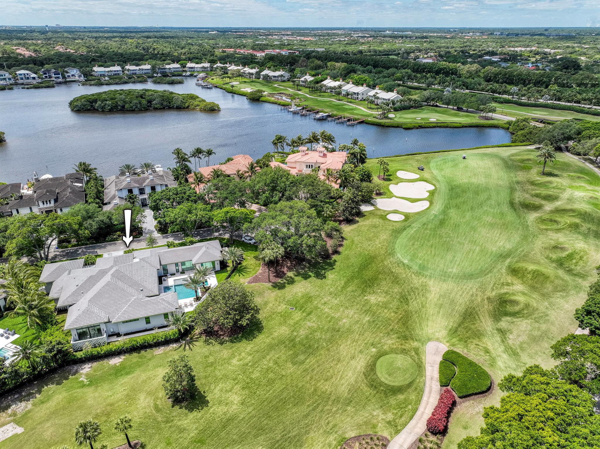 An exceptional property on a premium golf course location within the world-renowned Admirals Cove. This newly built,(2024) Jim Cherry constructed single-story masterpiece boasts four bedrooms, 4.1 bathrooms, and an expansive 3-car garage with a 4th garage for your golf cart. It luxuriously blends modern and classic design elements, offering an open & modern floor plan with spacious interiors crafted with the utmost attention to quality and detail. Conveniently situated close to the front gate and the clubhouse. This property graces a highly desirable cul-de-sac, and boasts an impressive & rare 200+ feet of golf course frontage. The stunning courtyard entry leads to your oversized living room. The entire home features soaring ceilings, a Lutron lighting system, plus designer-picked