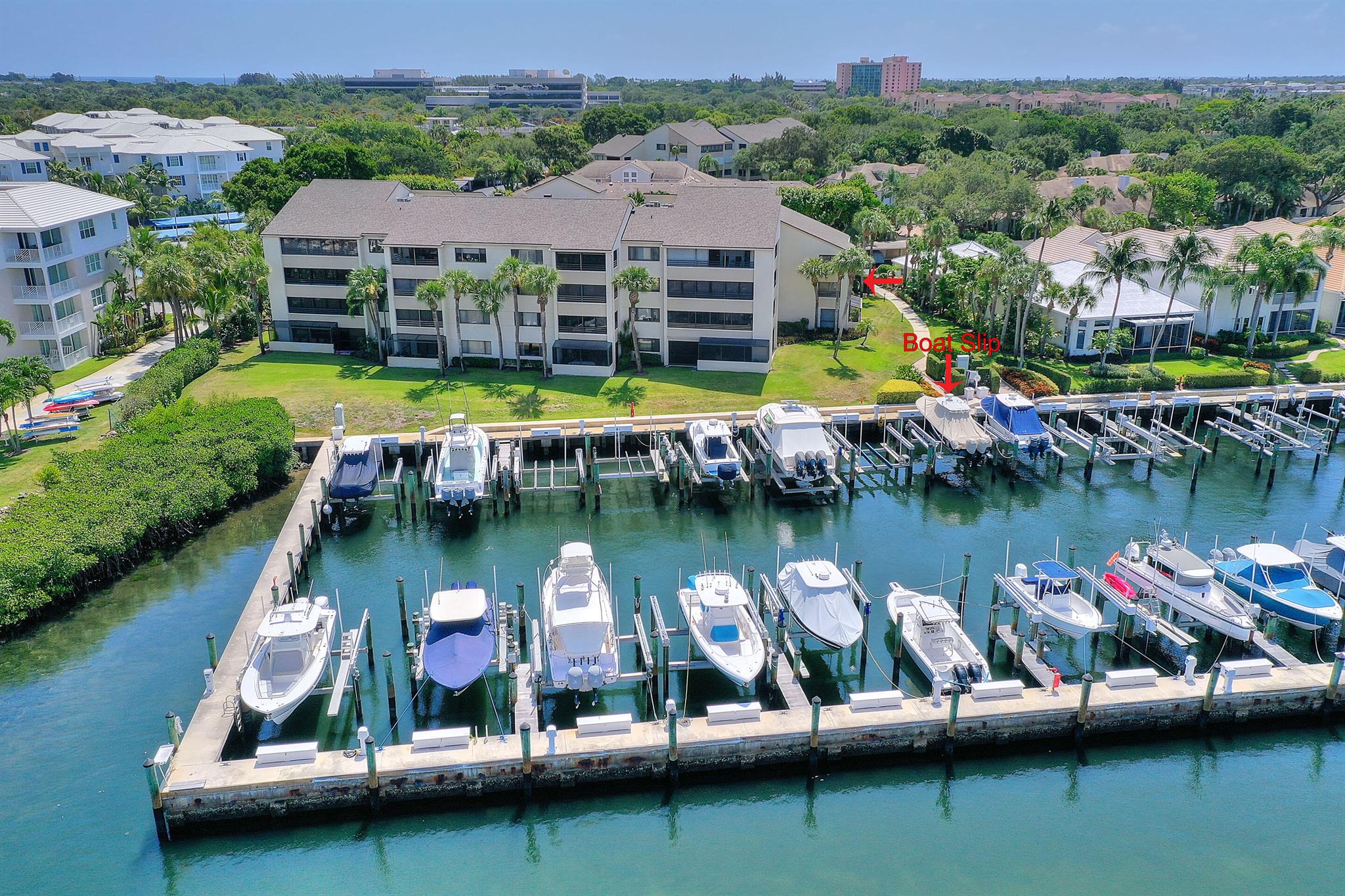 BOATERS PARADISE. CONDO AND DOCK. Beautiful waterfront condo first floor end unit a few steps to your boat dock. Dock is D-08 and has electric & water with a 20000 pound boat lift. Built in 2020. This is nestled amongst a gorgeous tree lines streets and mature landscaping. 2 bedroom and 2 bathrooms. Open floor plan. Screened in patio with a peek of Intracoastal. Clubhouse and fitness center, 2 pools, tennis courts. Resort style living with the beach and restaurants close by. Easy, relaxed living with all of the best of Florida has to offer.