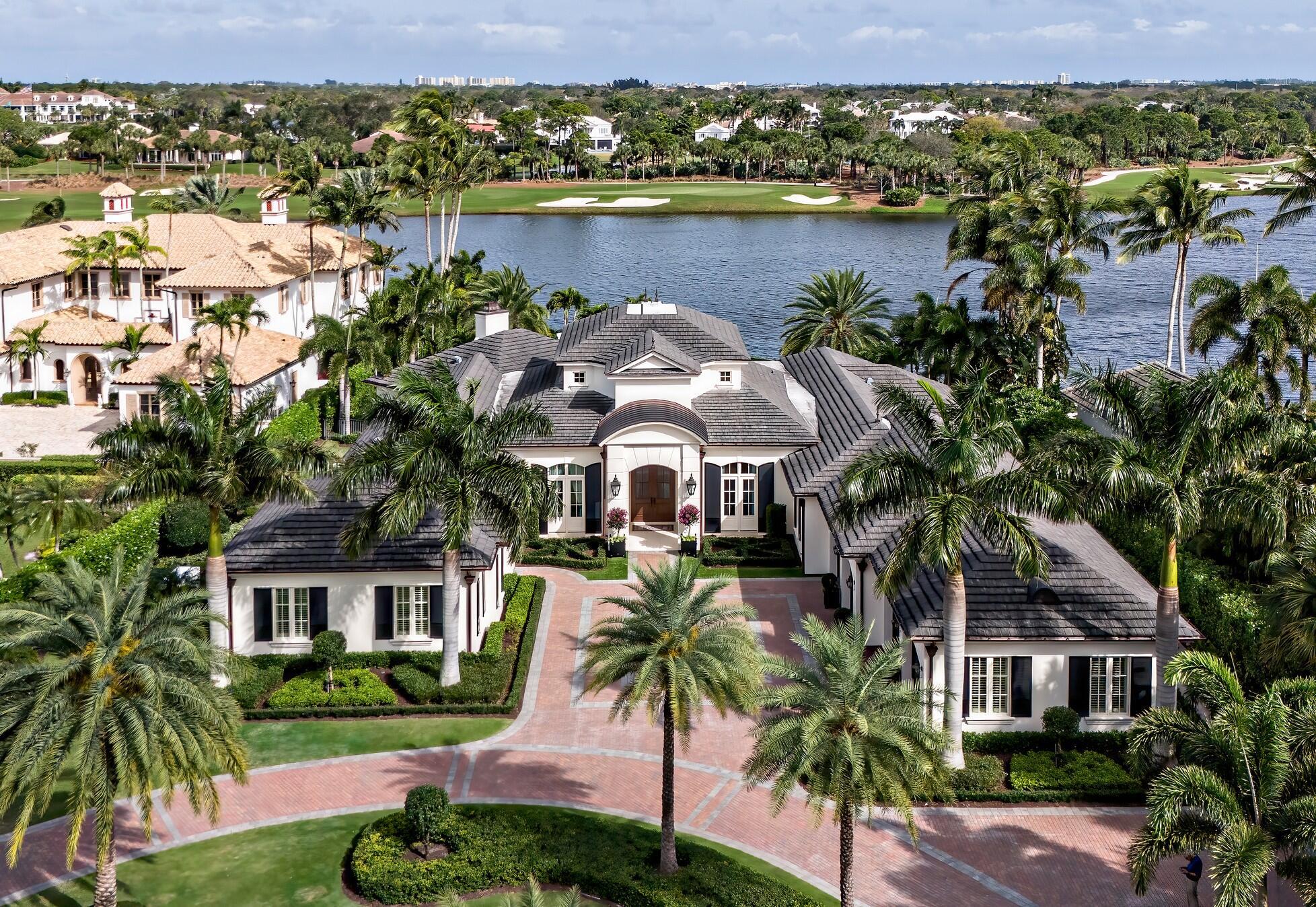Presenting an unparalleled waterfront residence on a spectacular .8 acre lakefront lot within the prestigious Loxahatchee Golf Club. This sprawling 6,355 square foot single-story estate has been masterfully rebuilt in 2020, offering a total of 9,150 square feet of luxurious living space designed for those who appreciate the finer things in life.This exquisite home boasts an open floor plan that seamlessly blends indoor and outdoor living. The heart of this estate is a chef's dream, an oversized kitchen equipped with high-end gourmet appliances, perfect for culinary exploration. The adjoining wine room can house over 450 bottles, ensuring every occasion is well catered for.SEE MORE Accommodations include two master suites and three generously sized bedrooms as well as 6.5 lavish bathrooms. The home also features a his and her office, providing ample space for professional activities and creative endeavors. The custom wood beam detail in the family room ceiling is a testament to the unique architectural design that spans throughout the residence.

Step outside to the breathtaking outdoor living area, complete with a living space, a cozy fireplace, and a fully equipped outdoor kitchen. The amazing pool, spa, and fire pit overlook the tranquil waters, making it an ideal setting for entertaining and relaxation.

Situated on the most desirable lot in The Loxahatchee Club, the property offers long and wide views of the pristine lake, making it one of the most incredible estate homes ever to be sold in this community.

This home not only promises a serene and luxurious lifestyle but also an investment in exquisite craftsmanship and architectural finesse. Make 236 Locha Drive your new sanctuary, where every detail is a stroke of genius and every day is a glimpse of paradise.