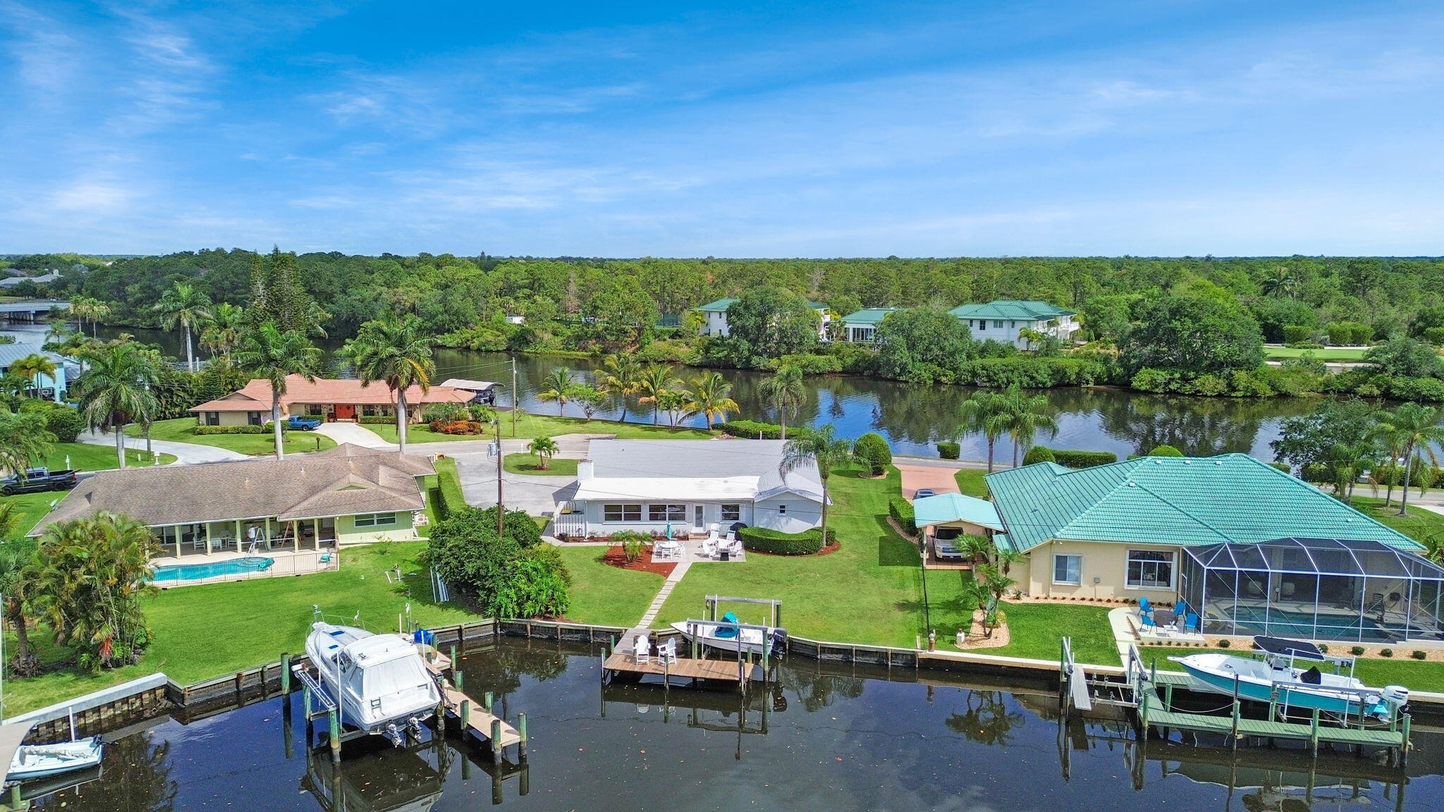 Discover this boaters paradise in Hidden River on Pine Tree Ln, boasts a private dock and a 10,000 pound boat lift along with a newer roof.  This charming CBS 3-bedroom, 2-bath home in scenic Palm City.  This one-of-a-kind lot features expansive water views both in the front and rear, enhancing its allure.  This property provides direct ocean access--no fixed bridges to navigate, making it ideal for boating enthusiasts. The spacious outdoor area offers substantial potential for customization, including ample room for a pool, perfect for creating your personal oasis. A rare opportunity to tailor and enhance in a sought-after neighborhood.  Partial seller financing possible.