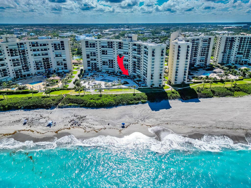 Welcome to Luxury Living at Ocean Trails, Jupiter Florida! Indulge in the epitome of coastal elegance with our Oceanfront condo.This professionally designed & decorated 2 bedroom, 2 bath unit uniquely situated on the 1st floor pool terrace level welcomes you. The custom-builtin features throughout offers unparalleled comfort & style. Step into spacious living with tons of storage and a private & gated grand walk-out terrace, perfect for enjoying alfresco dining while overlooking the brand new swimming pool and hot tub. Relax under shaded pergolas with breathtaking views of the atlantic ocean just steps away from the pristine beach. Inside discover a gourmet's dream with Subzero refrigerator & newer electrical appliances & wall oven. Admire the elegance of plantation shutters,custom quartz countertops, and porcelain floors, adding sophistication to every corner. Retreat to the brand-new main bedroom ensuite featuring a brand new luxury shower &amp; bath, complete with glass enclosure. Hurricane impact glass is complete and enjoy the convenience of a full-size stackable washer &amp; dryer. Experience resort-style living with tennis courts, pools &amp; miles of beach access. This unit is one of a kind situated directly next door to a club room &amp; fitness room. Additional storage, elevators and garage parking are very accessible from this terrace level. Don't miss the chance to make this oceanfront paradise your new home OR home away from home. Investors welcome too.