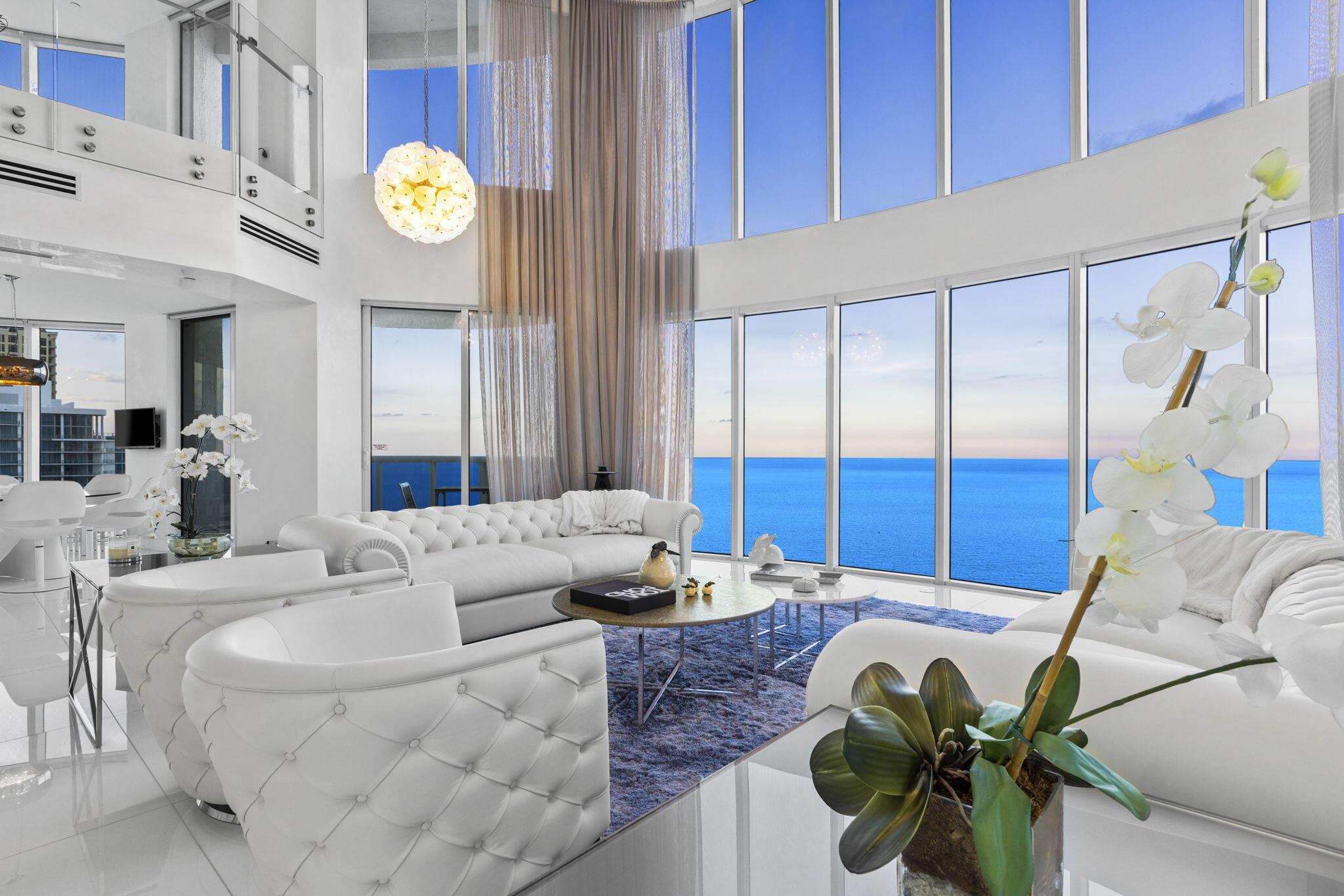 Welcome to the Queen of the Sky! Discover the epitome of luxury living in this extraordinary multi-level penthouse nestled in the heart of Sunny Isles Beach. This unparalleled residence is truly one of a kind, as it stands as the only penthouse unit in the entire building, ensuring unparalleled exclusivity and privacy. One of the largest primary bedrooms in any penthouse boasting its own wing including an office/gym flex space and unparalleled views.This unit has 6 open terraces (1,277 sq ft), an outdoor kitchen, entertainment bar, Bang and Olufsen surround sound throughout the entire unit, and a full 180 degree view of the ocean and city skyline. Crestron security system and fully smart penthouse unit. Electric shades on all windows as everything is automated for convenience. 3 parking spots included and extra storage. it's your very own mansion in the sky, boasting over 5,000 square feet of living space. Only 264 units at Ocean 4 and this penthouse is one of one. Amenities include Three story lobby, Beach-side cabanas, towel service, beachside cafe that delivers to your unit, Health and fitness center featuring state-of-the-art equipment, sauna, steam rooms and lockers, Oversized heated swimming pool and spa overlooking the Atlantic Ocean, 24-hour valet parking, Multi-level covered parking, Close to restaurants, food markets, banks and convenience stores.