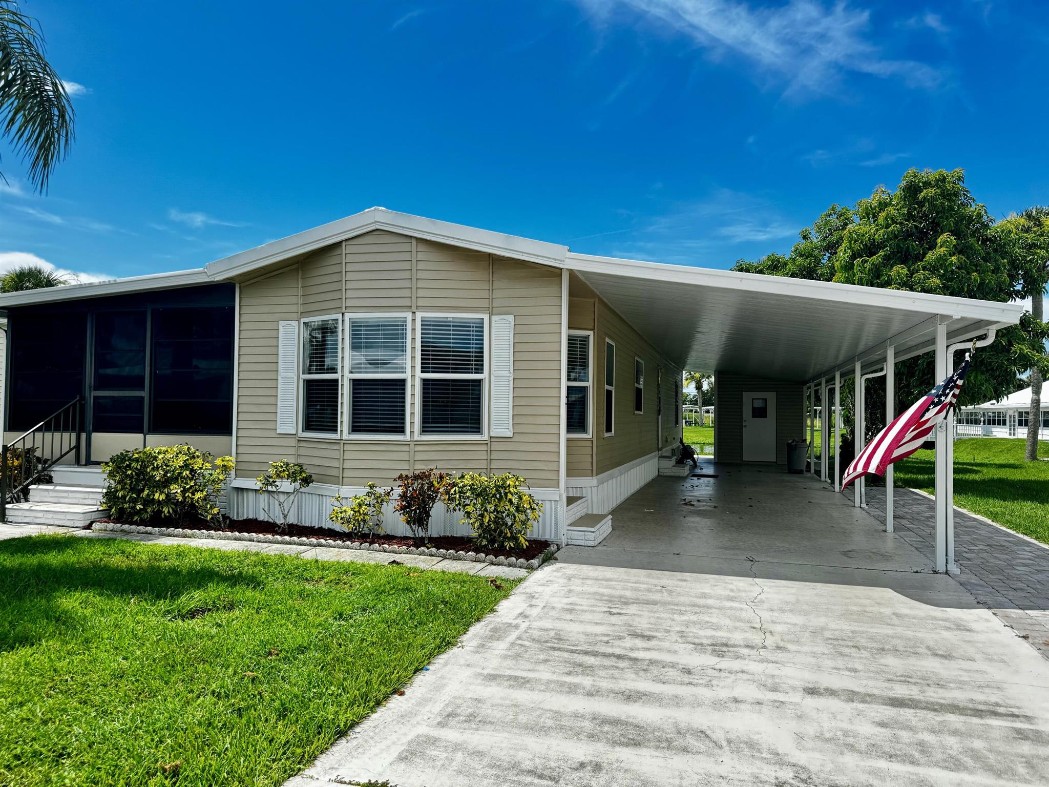 This beautiful two bedroom two bathroom mobile home is located in the Oasis Village a 55+ community. The home has new vinyl flooring throughout and has an open floor plan. There is a large screened porch right off the living room that looks over the pond. On the otherwise of the home there is a large carport that is two cars deep as well as a bonus area that has brick pavers so you can park your golf cart with ease of not having it in the driveway.  This mobile home is located in a great location of the park it is on the water and has the pond right behind it, as well as the pool, rec hall, and shuffle board courts. With several amenities you won't want to miss the opportunity to own in this park.