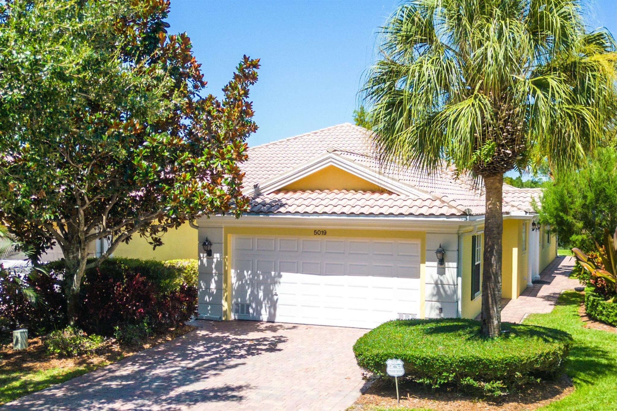 Welcome home to this beautifully maintained CBS block single-story townhome in Magnolia Bay offering a luxurious lifestyle. This residence features a split floor plan with two spacious bedrooms and two bathrooms. The open-concept living and dining areas flow seamlessly into a charming kitchen adorned with white cabinets and elegant quartz countertops. Have peace of mind with the following brand new appliances including new stainless steel appliances featuring a refrigerator, microwave, dishwasher, range along with a brand new HVAC and hot water heater installed in July 2024. A large patio with a rollout awning overlooks a serene lake, creating a perfect spot for relaxation and outdoor enjoyment. The home's hurricane panels ensure safety for your peace of mind. Magnolia Bay community boasts an array of amenities, enhancing your lifestyle with convenience and recreation. The clubhouse is equipped with a pool, gym, tennis courts, and playgrounds. Residents benefit from included services such as cable, internet, landscaping, irrigation and professional management, all within the secure confines of a gated community. Centrally located in desirable Palm Beach Gardens, this residence offers convenient proximity to restaurants, shops and pristine beaches making it an exquisite place to call home.