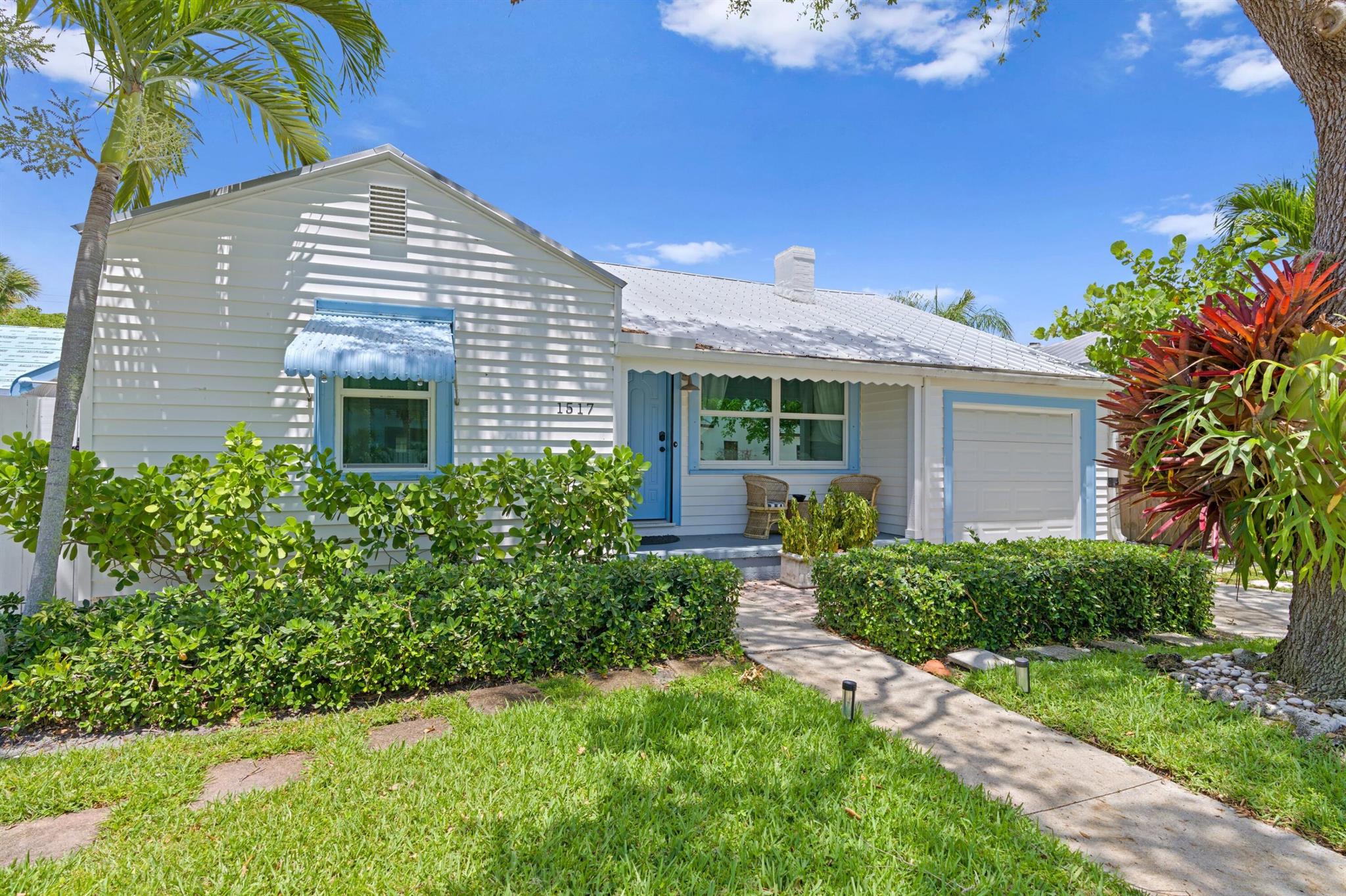 Adorable Florida Style Cottage on North Palmway in Lake Worth Beach. Updated kitchen and baths, original oak hardwood flooring, fireplace, and original plaster walls. All impact glass doors, and windows, and a metal roof. The lot os 5000 sq. ft. with room for a pool, and nicely landscaped. The back patio is all reclaimed brick pavers, fenced and gated. The garage is now a half garage used for storage, this area is not on the floor plan. The 2nd bath has the laundry inside for added convenience. 16th Avenue North has the north entrance to the golf course for walking etc. The electric has been updated, and the home is in move-in-condition. The home can be purchased turn-key furnished, adding a great short term rental option. The storage garage is not shown on the floor plan, a 1/2 garage.