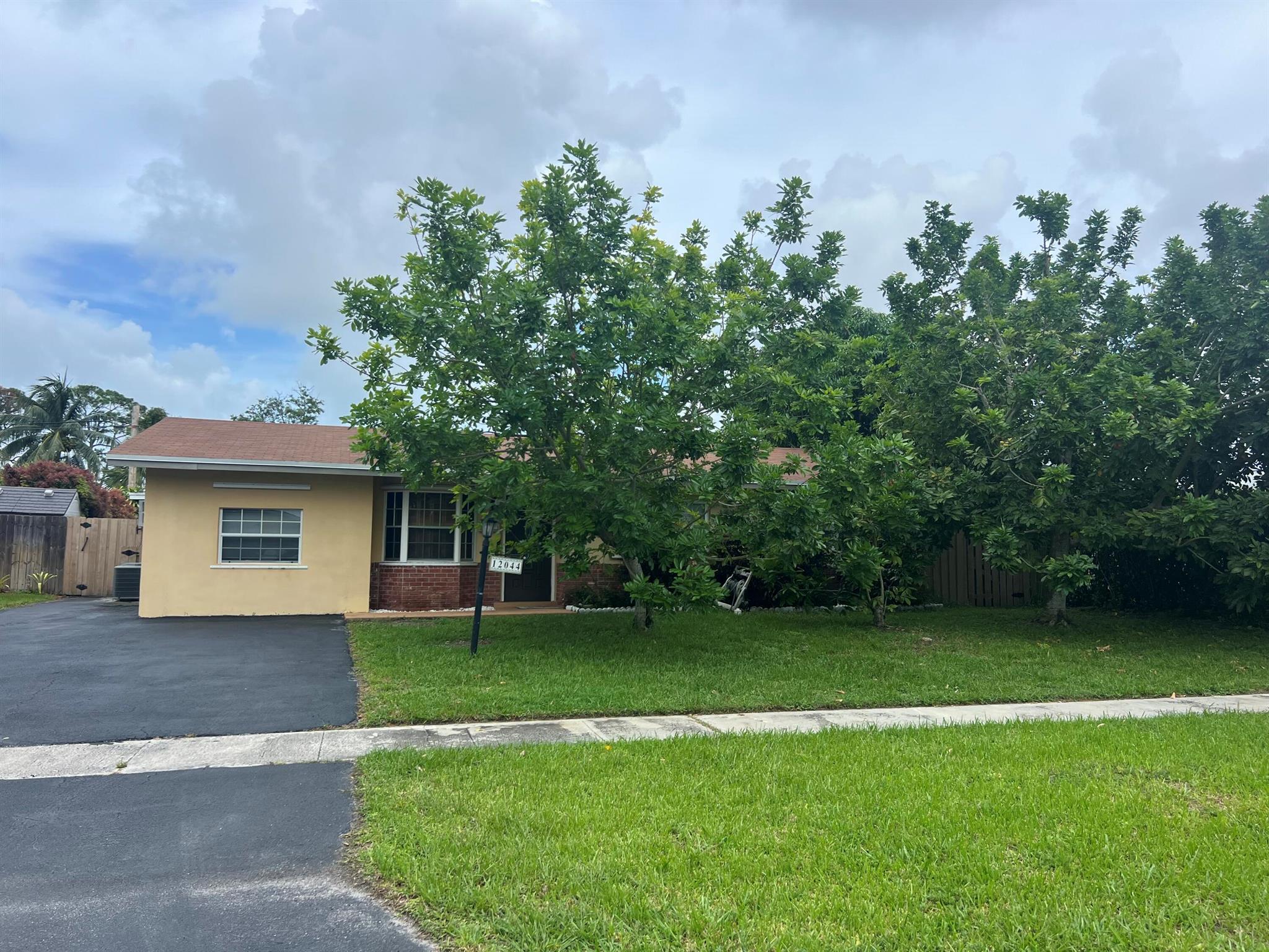 NEW ROOF (Installed 2024) - Inspection and FHA APPRAISAL Completed - READY to CLOSE -  3 Bedroom, 2 Bathrooms, Office/Nursery, Den/Music Studio, Formal Dining Room, Living Room, Family Room Single Family Home with Screen Patio and Tropical Fruit Trees. NO CARPET and NO HOA in the desired community within close proximity to Palm Beach Garden Mall, Juno Beach, and Downtown Palm Beach Gardens. Enjoy Golfing, dining, shopping, and going to the movies with friends. The area has ''A'' rated schools with an Elementary school within walking distance.