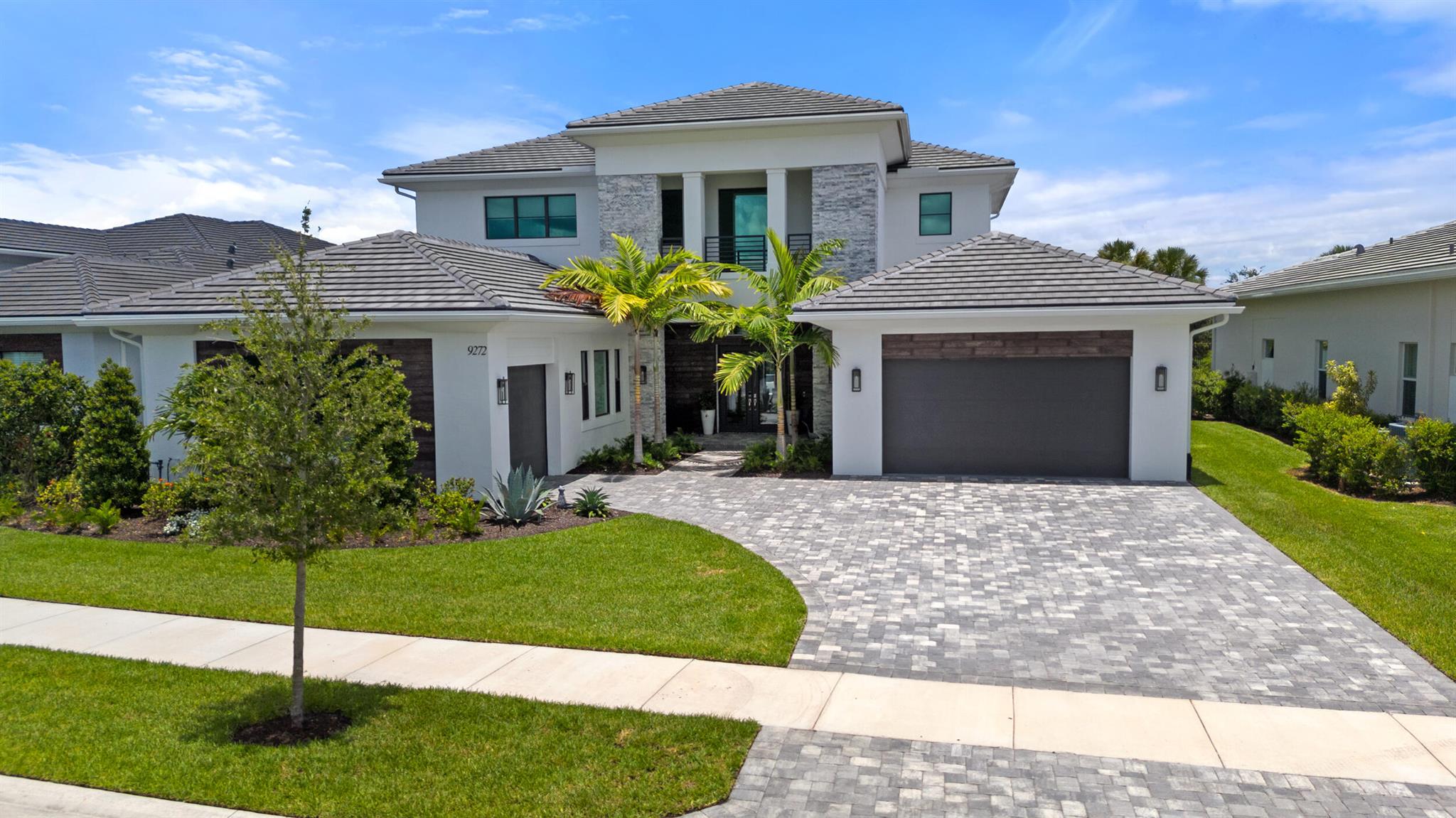 Welcome to your new home at 9272 Coral Isles Cir, Palm Beach Gardens, FL! Imagine stepping into 5322 square feet of pure luxury, designed just for you. With 5 bedrooms and 6.5 bathrooms, this single-family home offers plenty of space for everyone.As you enter, the double-story foyer with a custom chandelier you come into a beautifully designed great room with 12-foot ceilings and 10 foot sliding doors that showcase the grandness of this home. The kitchen is a chef's dream, featuring top-of-the-line appliances, an Italian range, and a stunning quartz waterfall island. Cabinet lighting, both upper and lower, adds a special touch. The outdoor space is perfect for entertaining or relaxing. The motorized patio screen opens up to a complete summer kitchen. The marble decking surrounds a gorgeous heated and salt-chlorinated pool, making it a perfect spot to unwind.

The first-floor master bedroom is a true retreat, with custom closets and a luxurious master bathroom that includes a soaking tub and separate shower. The club room, with its custom wall built-in, is ideal for movie nights or game days. Both garages have epoxy floors and built-ins.

Coral Isles and Avenir is the perfect place to call home. With a 250,000 sqft town center being built, that will bring world class restaurants and shopping. A 16,000 sqft clubhouse with a state of the art gym, resort pool, lap pool, splash pad, playground, pickleball and tennis courts to entertain the young and the young at heart. To top it off, enjoy the adjacent public golf center through our own entrance with an 18-hole course designed by Jack Nicklaus, a par-3 course, and a two-story driving range with ball tracking, golf games, a bar, and a store. You get all the benefits of a golf club without paying for a membership.

Make 9272 Coral Isles Cir your new home and start living the lifestyle you've always dreamed of!