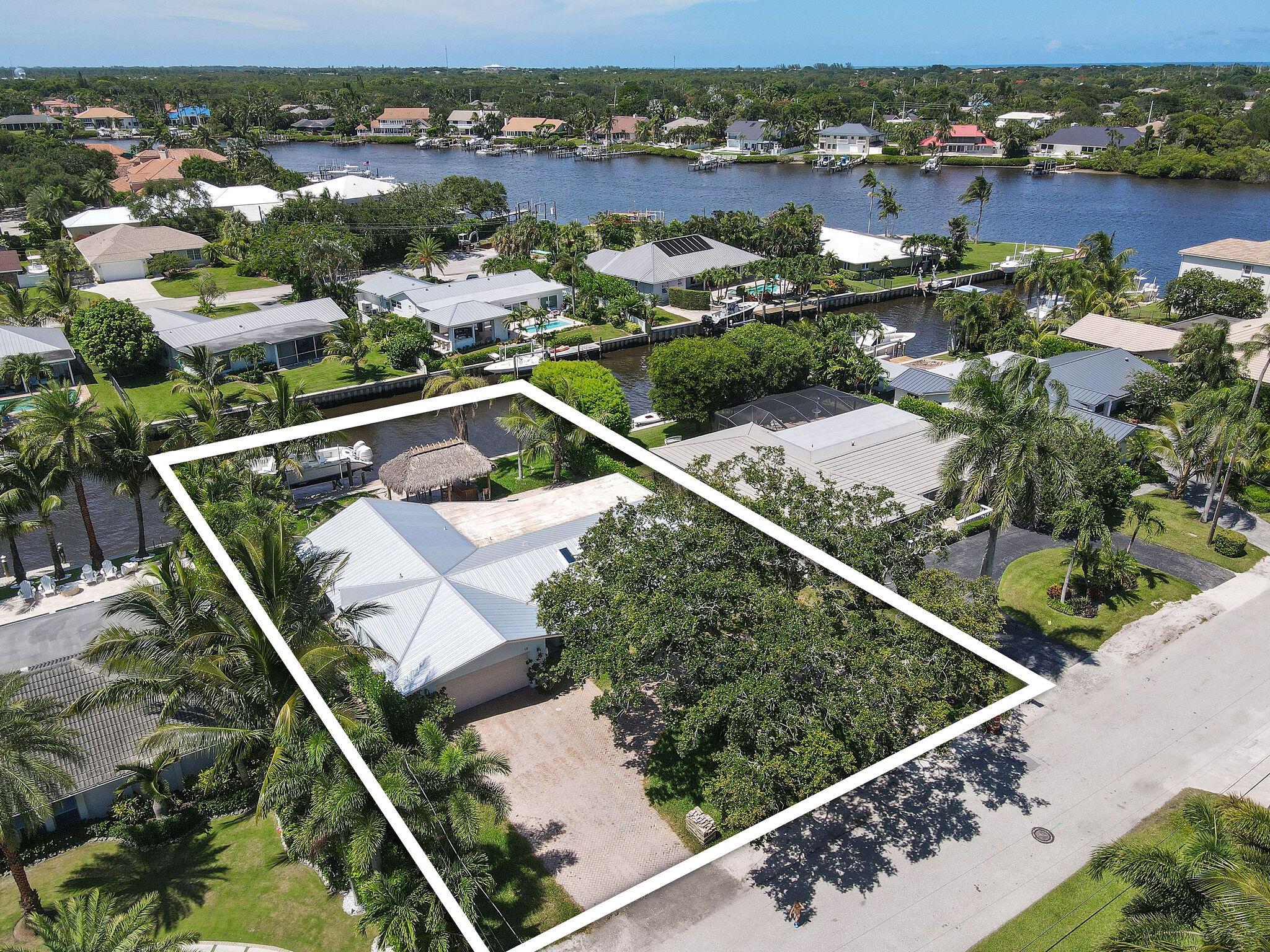 Nestled in the exclusive enclave of Country Club Point in Tequesta, this waterfront home presents an unparalleled opportunity for customization and luxury living. Inside, the home's interior is a blank canvas awaiting personalization. With the structure fully gutted and under construction, the potential is limitless for creating a bespoke residence tailored to the new owner's preferences and lifestyle. Situated on a beautiful waterfront lot with 85 ft of waterfrontage, the home offers views of the serene waterways that characterize Tequesta. The property features a private dock, pool area, and tiki hut, perfect for relaxing under the Florida sun or entertaining guests. Enjoy proximity to world-class golf courses, fine dining establishments, and boutique shopping, ensuring a lifestyle of both relaxation and convenience. For those seeking a waterfront sanctuary in one of Florida's most coveted locations, this property offers a rare opportunity to customize your dream home from the ground up.