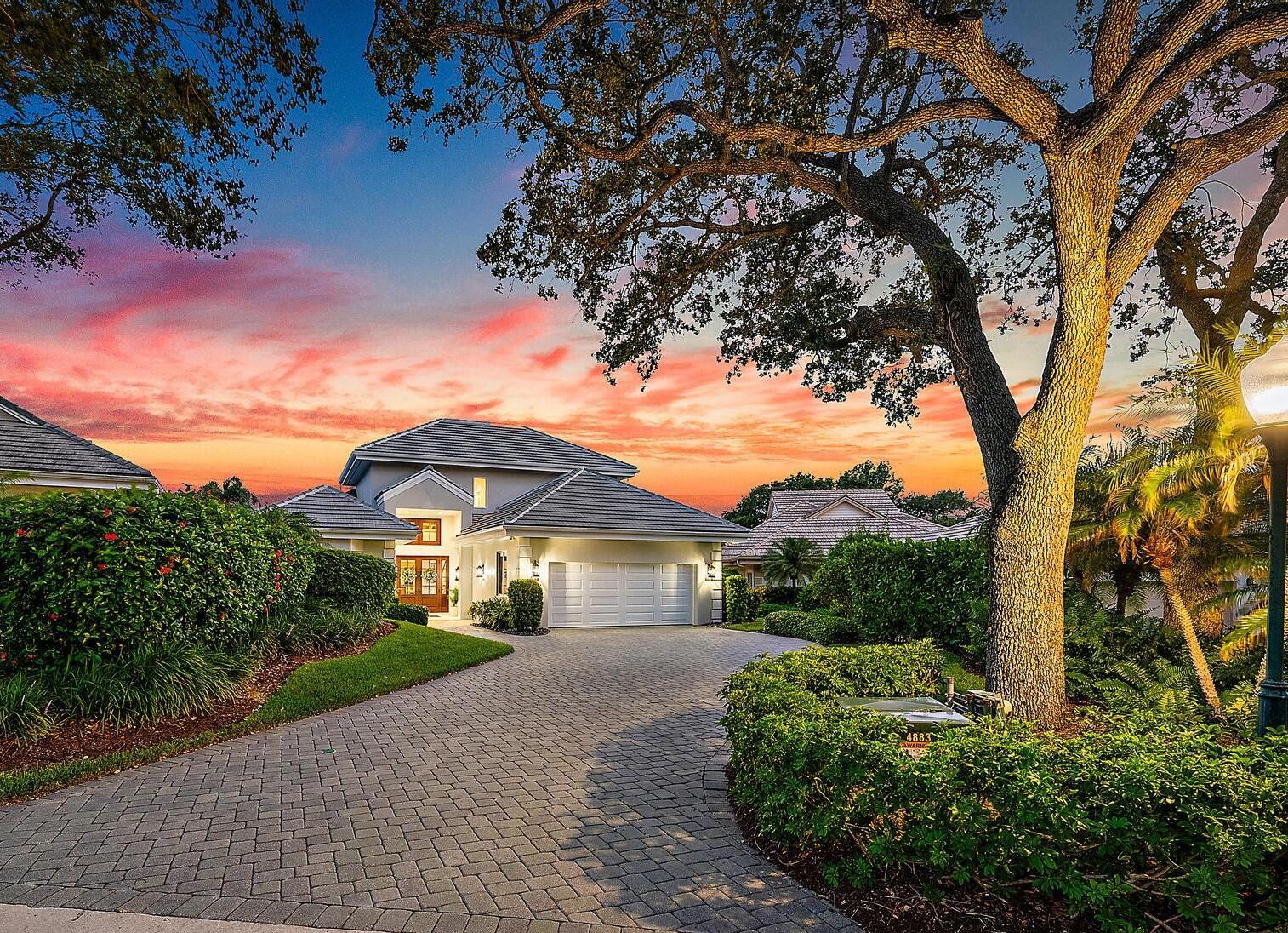 Nestled within the esteemed enclave of Jupiter Hills, this home presents a rare opportunity to reside in an exclusive private golf gated community.  The property showcases a fully renovated, turnkey residence, offering breathtaking views of the picturesque 15th hole of the Jupiter Hills Village golf course, situated on one of the community's highest elevations.  Notably, it offers the privilege of residing without a mandatory membership requirement. This expanded Prestwick model home captivates with extraordinary attention to detail. Meticulously maintained, it has seen substantial investment over the past two years in luxury and designer appointments. This home boasts a new roof installed in 2020, newly fitted AC units from the same year (with four AC zones throughout the home), full impact windows, a new Hoover awning across the patio, a new outdoor Mount Alpi modular grill with fridge, a water filtration/softening system and a whole-home generator.

The master suite features a dedicated seating area, separate vanities, custom closets, and luxurious fixtures. Throughout the home, meticulous updates abound, from fresh interior and exterior paint to custom cabinetry and woodwork throughout, lustrous hardwood floors, hardwood plantation shutters, a new custom bar and new bathrooms with Toto brand accessories. Every detail has been carefully considered, including custom window treatments and upgraded lighting fixtures, culminating in a residence of unparalleled quality and style.