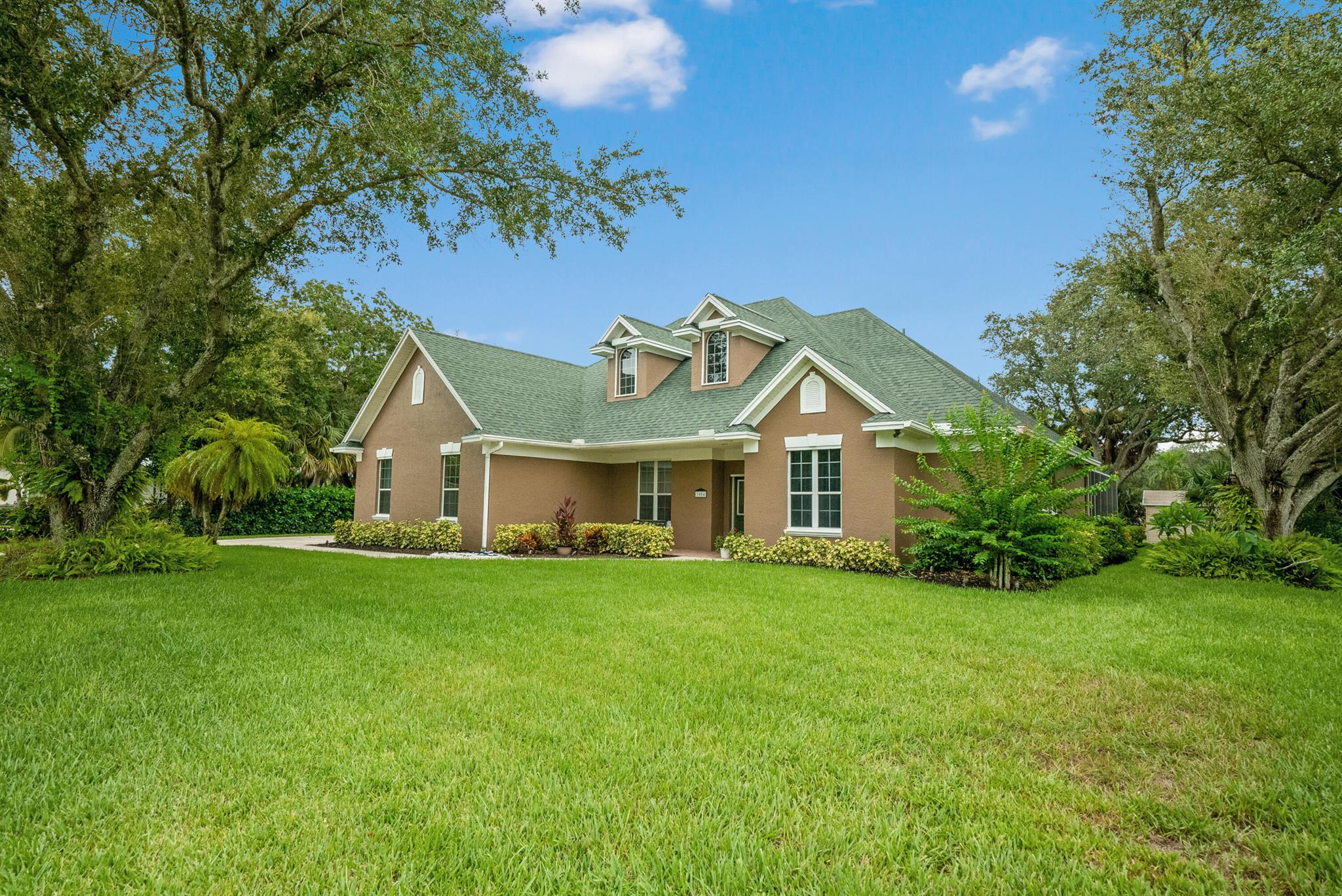 Welcome to your Forever Home! Lost Tree Estates is a boutique style community with just 28 custom homes & they rarely go for sale! 3004 Lost Tree Blvd is one of a kind, sprawling over 2700 sq ft with 10ft ceilings, 8 ft interior doors & rounded corners. Situated on a .5-acre lot the expansive driveway is already set up for your RV, with a 30amp power, water & sewage hookup. Drink your morning coffee under the covered patio overlooking the screened in heated/salt pool (Pool Pump 2022). In addition to having 3 beds, & 2 1/2 baths, there's an office, separate media room, formal dining room, formal living room, breakfast nook & family room. Roof (2013) Water Heater (2024) full window/door hurricane shutters, R30 Insulation, irrigation system powered by a well, freshly painted interior.