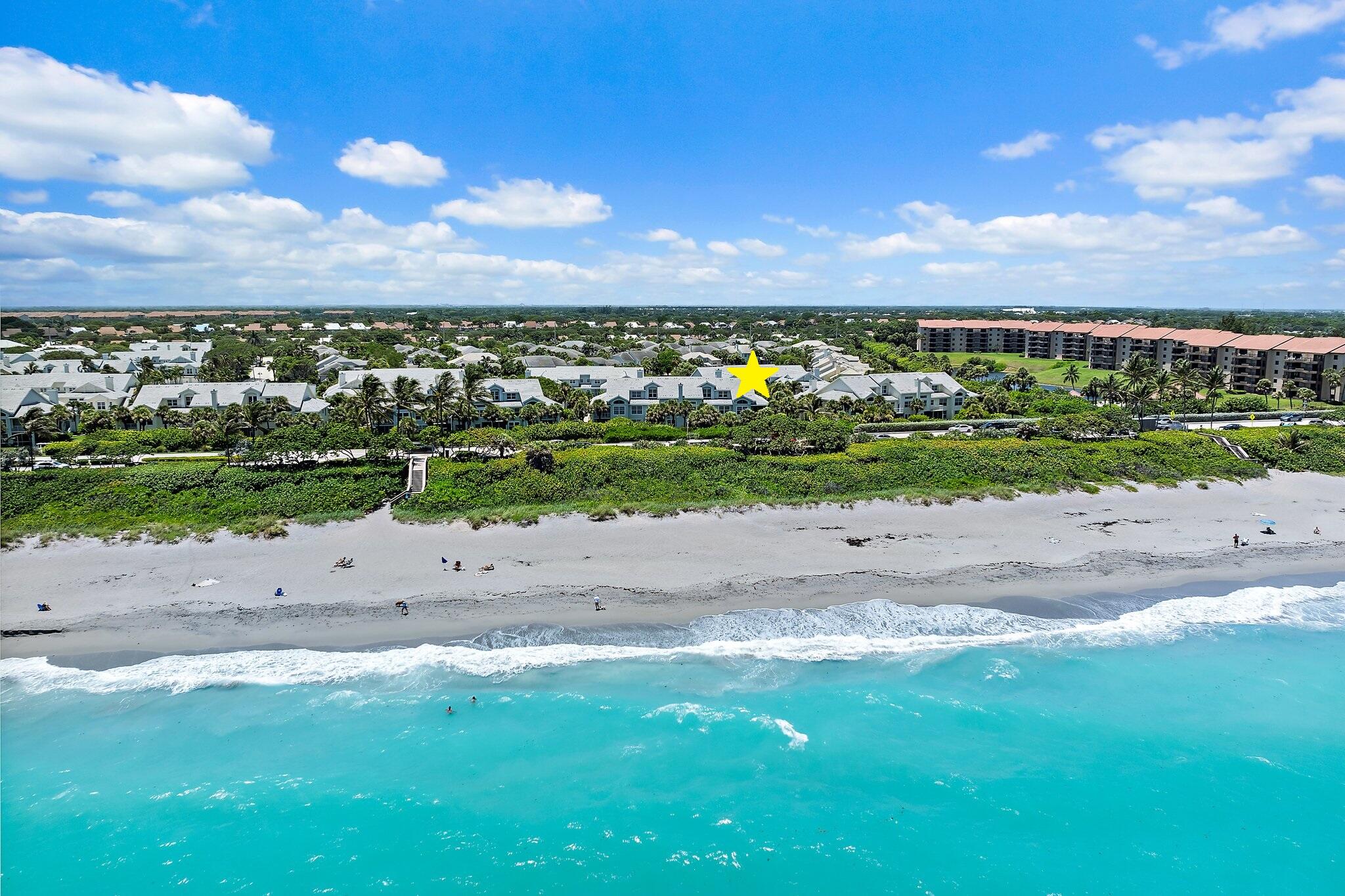 Elevated oceanfront living across from Jupiter Beach.  Terrific opportunity to lease a COMPLETELY RENOVATED EAST FACING END UNIT w/ private balcony perfect for enjoying the seaside breeze and a GARAGE! NEW kitchen with custom cabinetry, gorgeous marble counters, subway-tile backsplash and luxury appliances including Induction cooktop. Inviting living spaces with gorgeous NEW wood floors, plantations shutters, vaulted ceilings, large open dining area and comfortable social spaces. Split floor plan with the Primary suite and a guest bedroom on main level,  second guest suite is loft style.  Primary suite done up in a transitional modern style and neutral shades. NEW primary bath with beautiful marble details throughout, dual vanities, Toto auto toilet, and walk in closet.