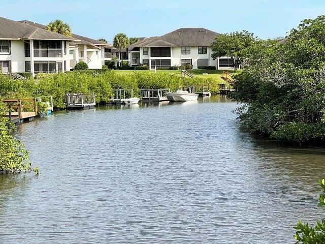 LOCATION, LOCATION, LOCATION!  RARE DEEDED DOCK!  Beautiful opportunity to enjoy watersports, fishing or viewing beautiful sunsets!  2 Primary suites, with ample closet space and updates in all 3 bathrooms!  Practical upstairs laundry with newer washer and dryer.  Reasonable HOA allows large size dog, motorcycles and trucks.  2 community pools, clubhouses. Exterior Insurance,  Water/sewer, cable, Bluestream Fiber Internet and more included in monthly fee!