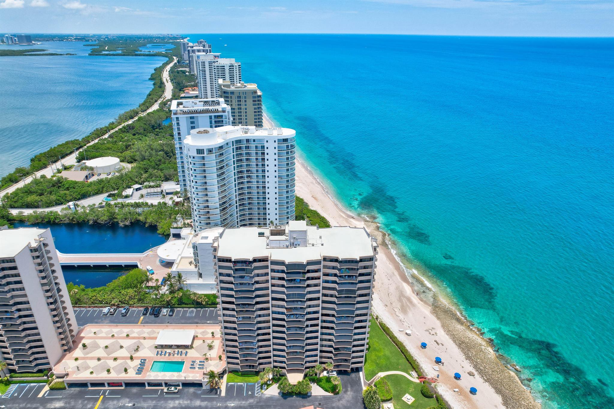 Enjoy every sunrise and sunset from both Balconies with expansive ocean & Intracoastal views! This delightful Singer Island Condo has 2 Bedrooms, 2 Bathrooms with Hurricane Impact Windows, floor-to-ceiling glass sliders in an open living & dining space, split floor plan, updated kitchen & bathrooms, granite counters, built-in cabinetry, custom pantry, no popcorn, and ceramic tile throughout.  The building has completed certification, has ample reserves, and no assessments are pending. Enjoy a Covered Parking Spot (#222) right near the entrance. The building has new elevators. Amenities include private beach access with beach chair service available, pool, gym, sauna, and tennis courts.