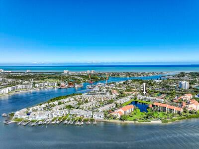 Experience waterfront living at its finest in this Jupiter Harbour townhome, boasting over 2900 sq. ft. of refined elegance. Breathtaking views of both the serene lake and the majestic Intracoastal Waterway create a picturesque backdrop. Currently finishing a meticulous renovation, this residence has been transformed with brand-new bathrooms and a modern kitchen, complete with custom, cabinetry, designer, fixtures, quartz countertops, and Samsung, Bosch, & GE Monogram appliances. The addition of hurricane impact glass (except sunroom) ensures both safety and unobstructed views. Live in luxury amidst this exquisite blend of style, comfort, and panoramic vistas. Jupiter Harbour offers 24 hr manned guard gate, resort style pool, marina, tennis, and pickleball. Paddle board/ kayak access!