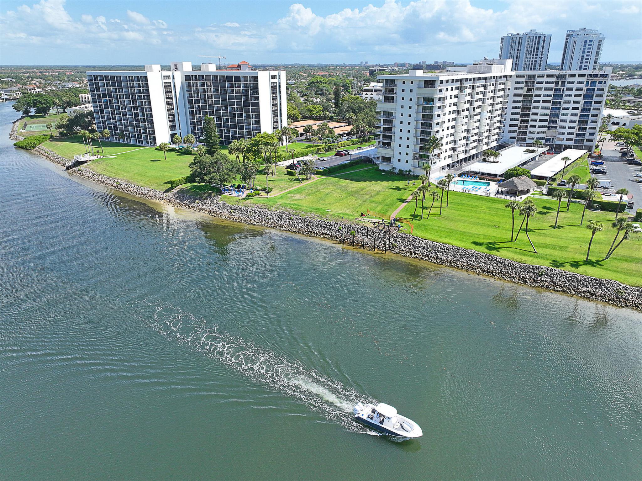 ENJOY SUNRISE & SUNSET VIEWS DAILY! RARE END unit offering a 40' covered wrapround balcony w/ direct waterfrontage, golf course, ocean & million dollar views from the 10th floor! Enjoy ocean breezes & watch boats go by all day every day. Larger end unit floor plan features over 1,400 SF of living space & 200 SF of outdoor space. Luxury plank flooring, renovated kitchen w/ water view, plantation blinds, new paint, custom closets, dining room plus 2 large bedrooms. Also add'l storage on the floor, covered deeded parking space, doorman in lobby, condo fee includes all utilities except electric. Milestone inspection completed, new roof in 2021, pool w/ tiki hut, kayak & paddleboard storage, bike storage, waterfront BBQ and day dock. MUST SEE THIS BEAUTY TO BELIEVE IT!