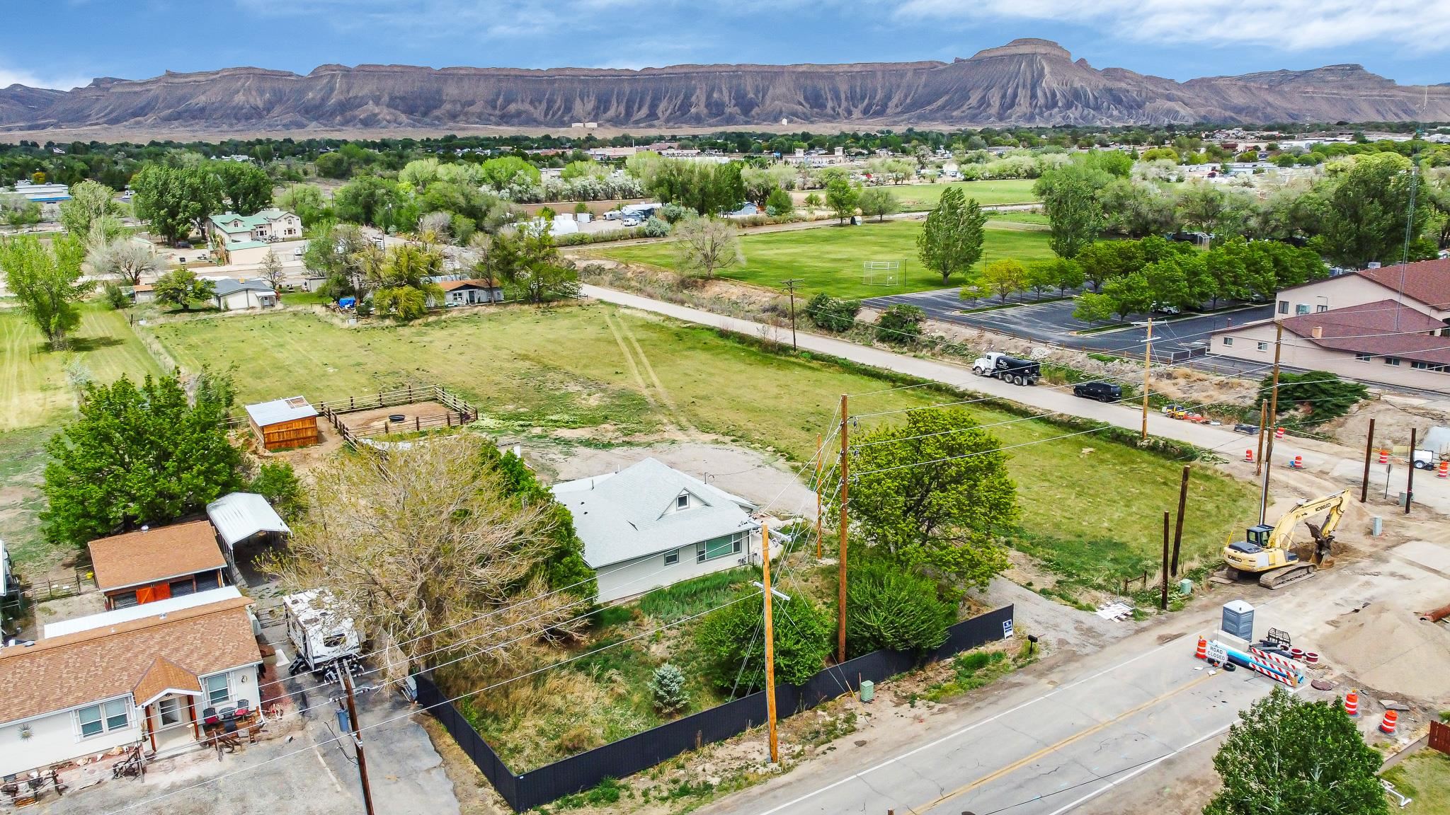 Completely REMODELED Charming Farmhouse FULLY FURNISHED on 2.97 acres in the city!  CENTRAL AIR & heat!  Completely UPDATED to modern standards!   The pasture is flood irrigated, with four shares of GVIC water off of a private headgate, and two cisterns with attached gated pipe along the North property border. The 1915 Farmhouse has new energy efficient electrical, plumbing, and HVAC systems, including central A/C and a newer energy-star roof!  The entryway has a sunny window seat and opens to the living room and formal dining room. The kitchen includes soft-close custom cabinetry, butcher block counters, under cabinet lighting, a pot filler above the stove, and slate-finish GE appliances. There are breathtaking views of Mt. Garfield from the eat-in kitchen! The generously sized master bedroom features dual matching closets and an en-suite 3/4 bathroom with walk-in rain shower. Three other bedrooms are on the main floor, one with an attached jack-and-jill full bathroom. All three bathrooms are beautifully remodeled. The fifth bedroom has a private staircase to its upstairs location with two large storage closets and charming lofted ceiling. The 4th bedroom downstairs can also be used as a nice second living space. Outside, you will find a ready-to-use chicken coop, extended lean-to storage and horse set-up, plentiful parking, and mountain views in every direction! The front yard has a sprinkler system and fruit trees. This is a one of a kind property, just minutes from the city.