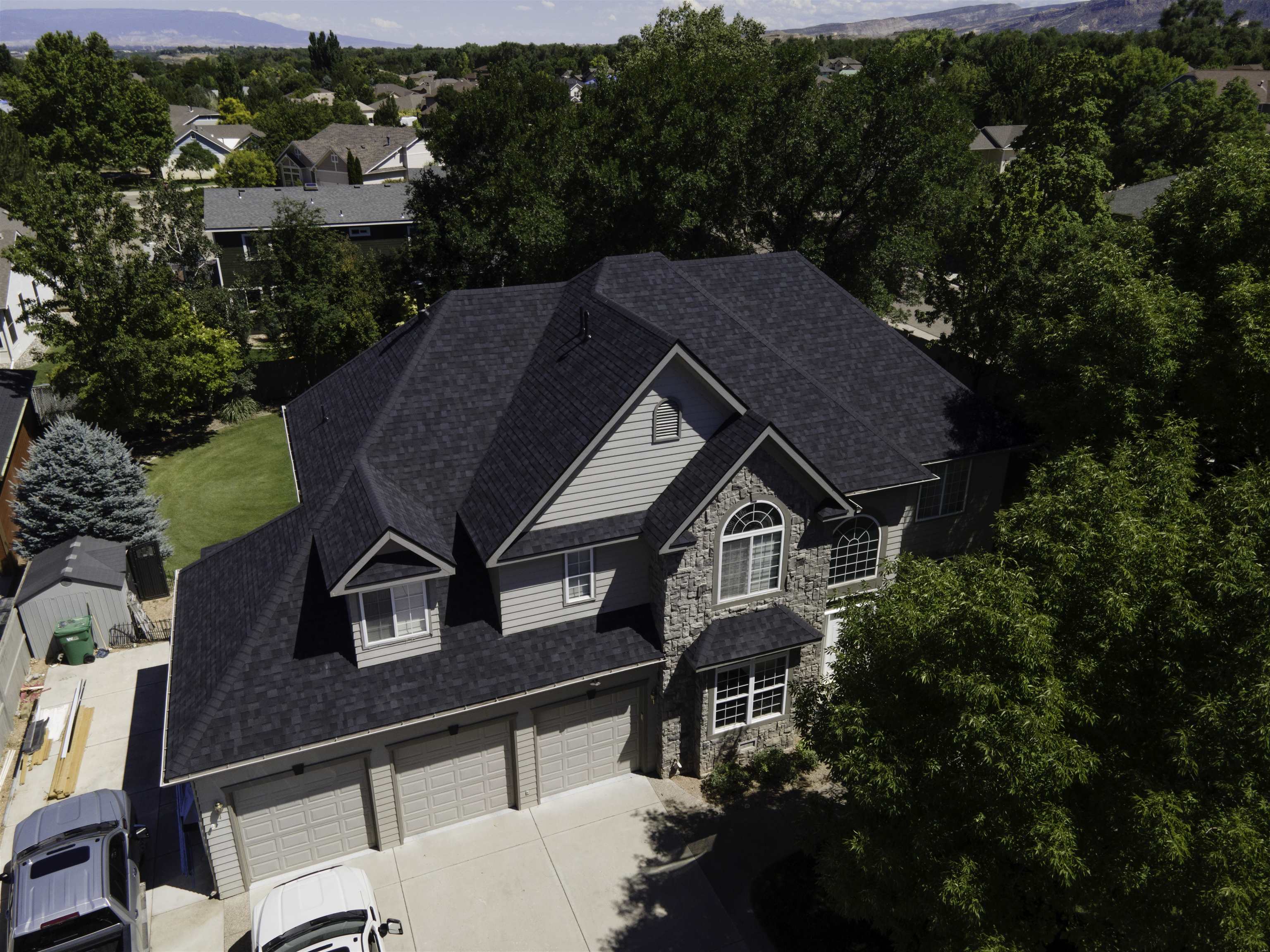 Welcome to 702 Woodland Country! This stunning Redlands home was remodeled in 2018 to update into pure luxury! This beauty has 4 bedrooms, 2.5 baths, a 3 car garage with RV parking, a huge yard and so much room to entertain. This open concept main level offers plenty of room for large gatherings. The formal dining room flows into the living room. Enjoy the morning sun in the casual dining room which connects to the kitchen. There is a laundry room located in the mud room with easy access to outdoors. Upstairs you will find the glamorous primary bedroom with a massive closet / dressing room. This comes equipped with its own washer and dryer space. The original 4th bedroom was converted to provide this suite. 2 more large conforming bedrooms reside on this level, as well. The family room can serve as the 4th bedroom and has access to the back deck. A dropdown ladder stairway opens up into the unfinished attic. There is sooo much potential up here! Turn it into a family room, play room, man cave or storage space. The updates throughout this spectacular property give it a bright, airy feel. Cozy up by the fireplace or host a barbecue. The backyard is a serene escape! Enjoy views of the Colorado National Monument and the entire Grand Valley. Hit the trails within minutes. This home truly has it all! Central air and a new roof are currently being installed. Central Air and a new roof have been installed as well as additional insulation in the attic. Book your private showing!