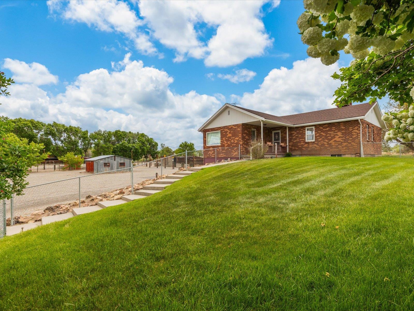 Lender Incentive To the Buyer Alert*** The Lender is offering 1% of the loan amount at closing to apply toward closing costs and/or rate buy-down. This incentive can be used in conjunction with any seller concessions! Call me for details!   We are pleased to introduce you to this North Grand Junction property! This rancher with a full walk-out basement boasts 2776 of living space. This beauty offers 4 bedrooms, 3 bathrooms, original oak flooring, updated tile, paint, and a newer roof. On the main level, you are greeted with an open-concept kitchen, dining, and family room, two generous bedrooms, two bathrooms, and a gas fireplace. Take a stroll downstairs and you are greeted with a fully finished walk-out basement with updated tile flooring, a second family room, a second gas fireplace, two bedrooms, a bathroom, a laundry room, a safe/flex room, a workshop, and under stair storage.  Privacy, views, and a park-like feel you are sure to appreciate! The generous 4.78 acres include 5 class 1 irrigation shares. You can grow your crop of choice or make a lovely pasture for your horses. This lot can be subdivided while still maintaining your privacy! NO HOA!  This property offers unmatched views from every direction combined with mature landscaping.  For the equine enthusiasts, you'll appreciate the lighted riding arena that has been well maintained.  The lush grounds include a Pole Barn, tack room, and a 28 x 22 workshop, chicken coop with plenty of storage. The possibilities are endless with this hidden gem!  Please, see additional home features for a complete list.  Schedule your personal tour today!