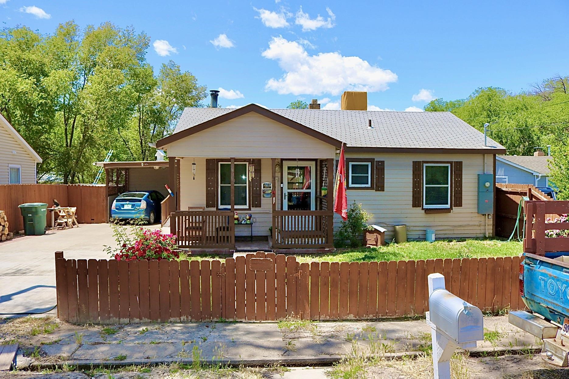 Discover comfort and convenience in this cozy home. This lovely home offers 2 bedrooms and 1 bathroom, ceiling fans throughout the house and original wood floors. Warm up with EPA approved wood burning stove in the winter, or if you prefer, forced air heat. Fridge and stove stay with the house, kitchen has laminate flooring. All electrical has been recently upgraded. The outside of the house features a covered back patio with screen, a covered carport and a covered front porch and handicap ramp with railing leading to the back entry of the house. The front yard is landscaped with beautiful rose bushes. The exterior of the house is freshly painted. The shutters on the windows add a little something special to the house along with the flower beds below the windows (shutters do not open). The home also features a great workshop and a brand new 10'x12' storage shed located in the back yard. Covered wood bins are located in the SW side of the home to store wood for winter. The surrounding features include Las Colonias Park, and the walking and bike trails are an added bonus! This home is centrally located and the peaceful neighborhood offers tranquility. A must see!