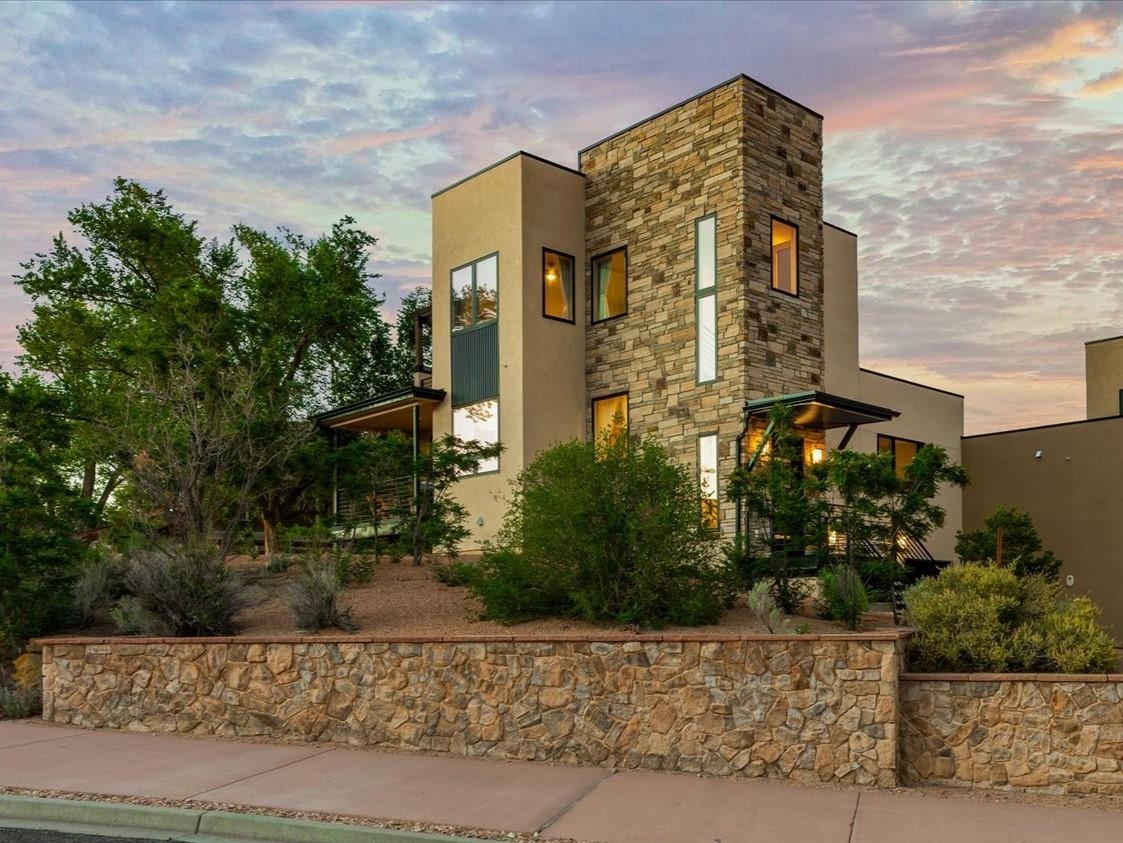 Featuring the captivating backdrop of the Colorado National Monument and Redlands Mesa Golf Course, this beautiful home offers 2,600 square feet of luxurious and comfortable living space! Offered as a turn-key home with furnishings (and the golf cart!) included, this spacious property features four bedrooms, four bathrooms, an oversized two car garage (plenty of space for two vehicles plus recreational items, storage and a golf cart!), two living areas and multiple outdoor decks.  The private primary suite occupies the entire top floor and features an expansive en-suite bathroom with a generous soaking tub and luxurious shower, as well as a generous top-level patio.  This retreat is THE perfect space to unwind.  The main floor offers an open layout with beautiful finishes, creating a bright and inviting atmosphere. The open-concept kitchen is ideal for cooking, complete with beautiful appliances, and ample counter space, while the adjacent dry bar adds a touch of sophistication and elegance which enhances your entertainment options!  Enjoy the main-floor deck as it opens to the living and dining rooms, inviting the beautiful outdoors and unbelievable views into your home.  A second suite and third bedroom are found on the main level too.  The lower level offers another living area, and a fourth bedroom, both proving plenty of room for relaxation and guests, as well as garage access.  You'll appreciate the large walk-in closets and granite countertops found throughout the home.  The premier location at the new Casas De Luz subdivision, nestled in near Redlands Mesa Golf Course and the course’s Club House, this home offers the perfect combination of luxury and convenience, with easy access to outdoor recreation (lunch loops, Redlands Mesa Golf Course, Colorado River, Colorado National Monument, Downtown Grand Junction) and local amenities.  Offered as a turn-key home with furnishing (and golf cart!) included, this is an ideal home, second home, or vacation rental.  365 W Ridges Blvd is more than just a home, it's a lifestyle.  Contact listing agent for details; all information subject to change/error, buyer to verify all information.