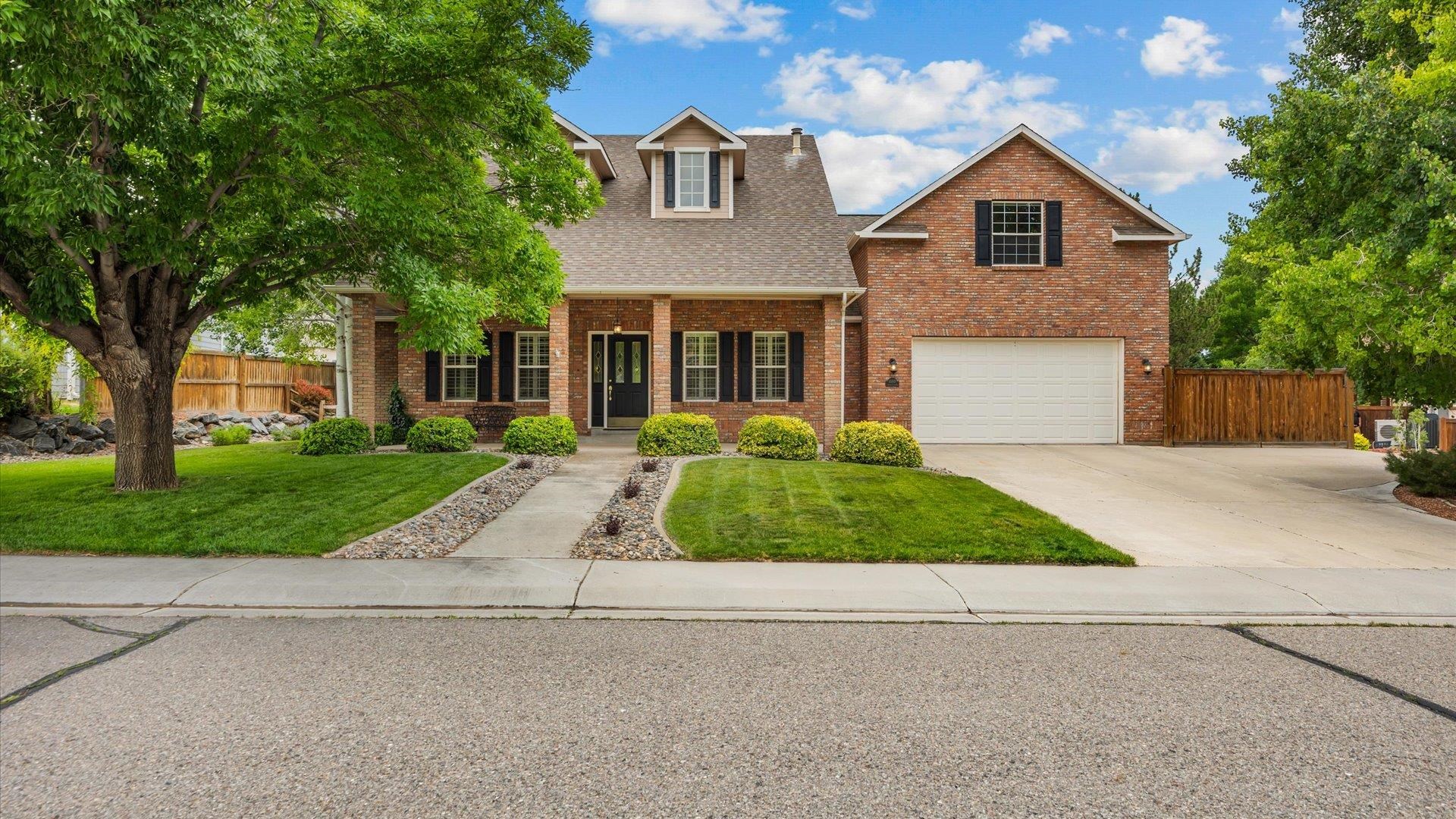 Discover luxurious living in this stunning brick home, priced to sell and offering  views of the Colorado National Monument. Featuring 3 bedrooms plus a loft (or 4th bedroom), 3 bathrooms, and 3 gas fireplaces, this home promises comfort and elegance. Enjoy a lifestyle close to nature with hiking and biking just minutes from your doorstep. Indulge in a cup of coffee on your spacious and enclosed back porch. Beautiful, matured landscaping on .25 of an acre. Embrace the perfect blend of luxury and recreation at 689 Country Meadows Drive. Don't miss this one!